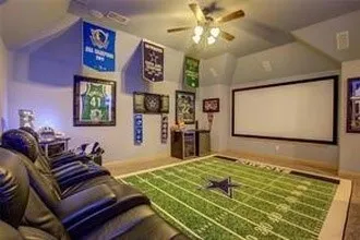 Vaulted ceiling with a ceiling fan, wall-mounted projection screen, built-in cabinetry, and recessed lighting