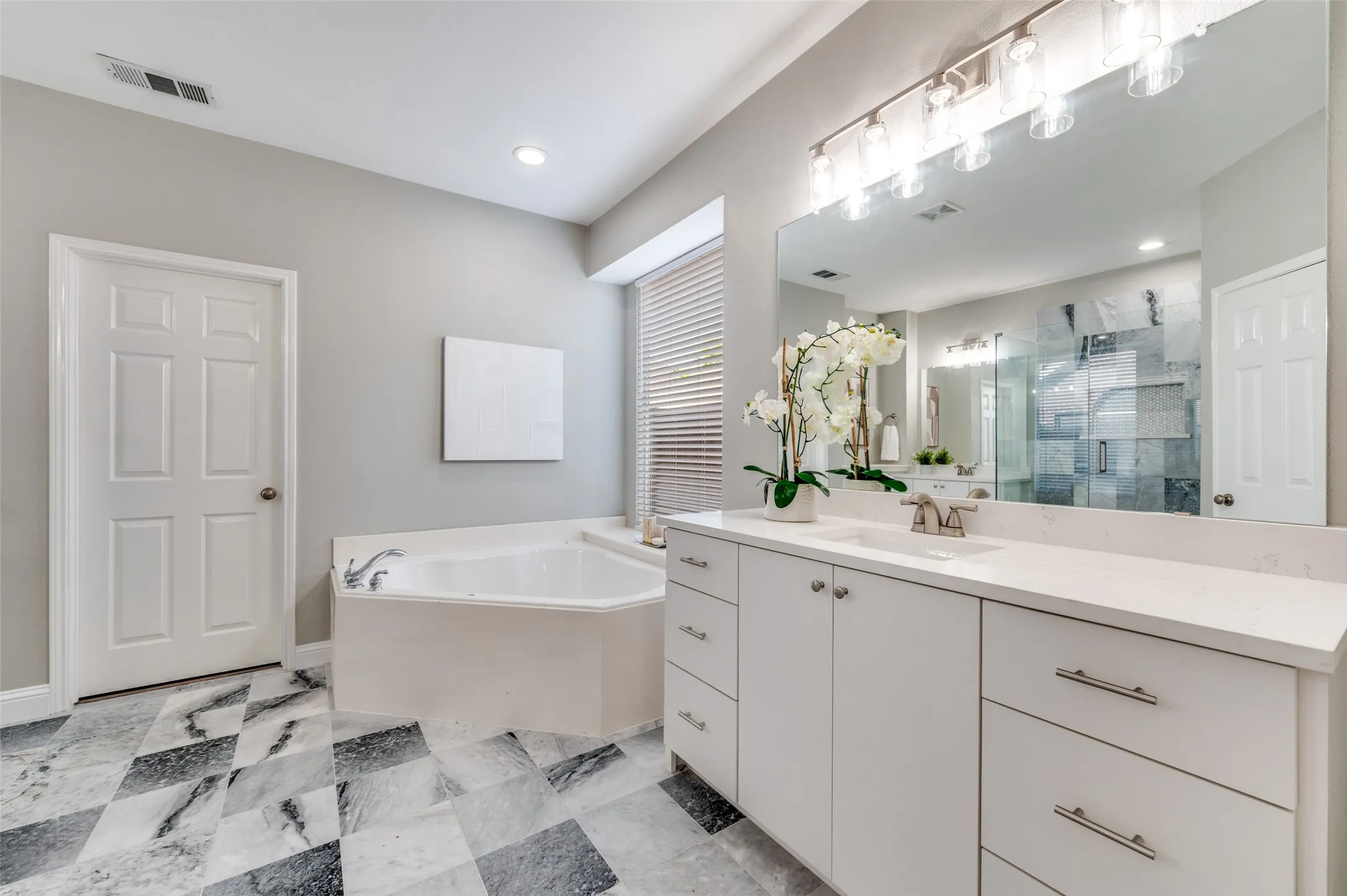 Dual vanity with white cabinetry and integrated sinks