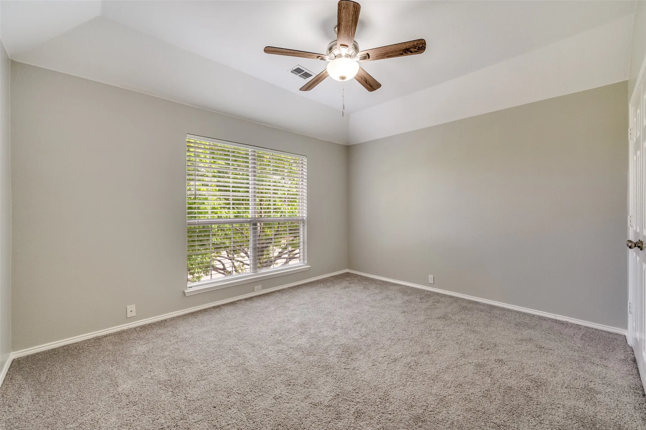 Bedroom 2 Vaulted ceiling, carpeted flooring, a ceiling fan with light fixture, and a window with blinds