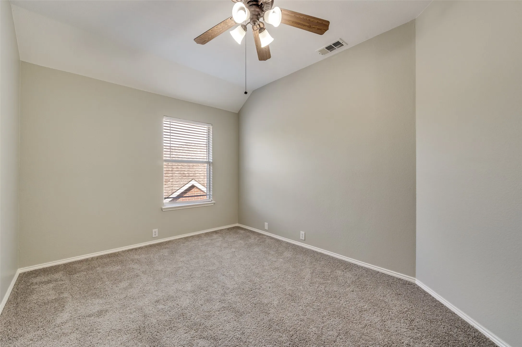 Bedroom 4 Vaulted ceiling with a ceiling fan, neutral carpet flooring, and a single window with blinds