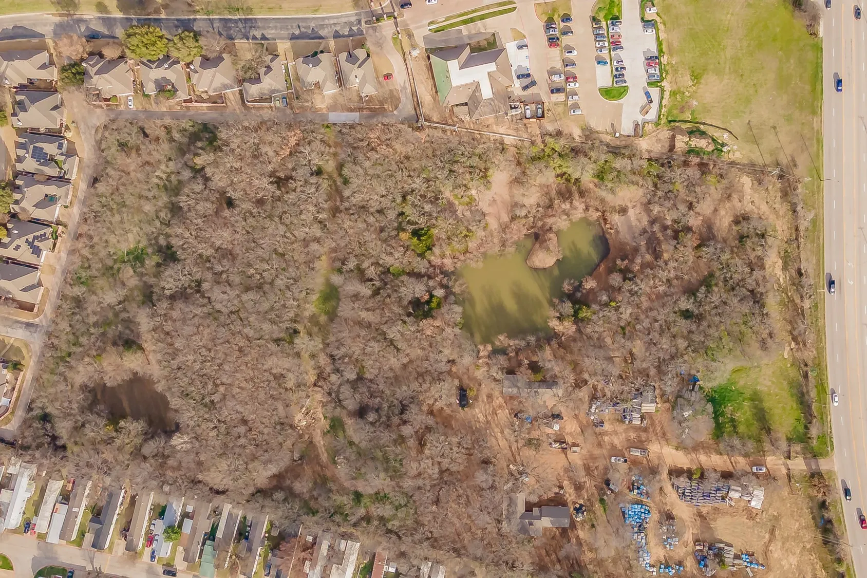 Expansive wooded acreage featuring natural water elements and direct road frontage