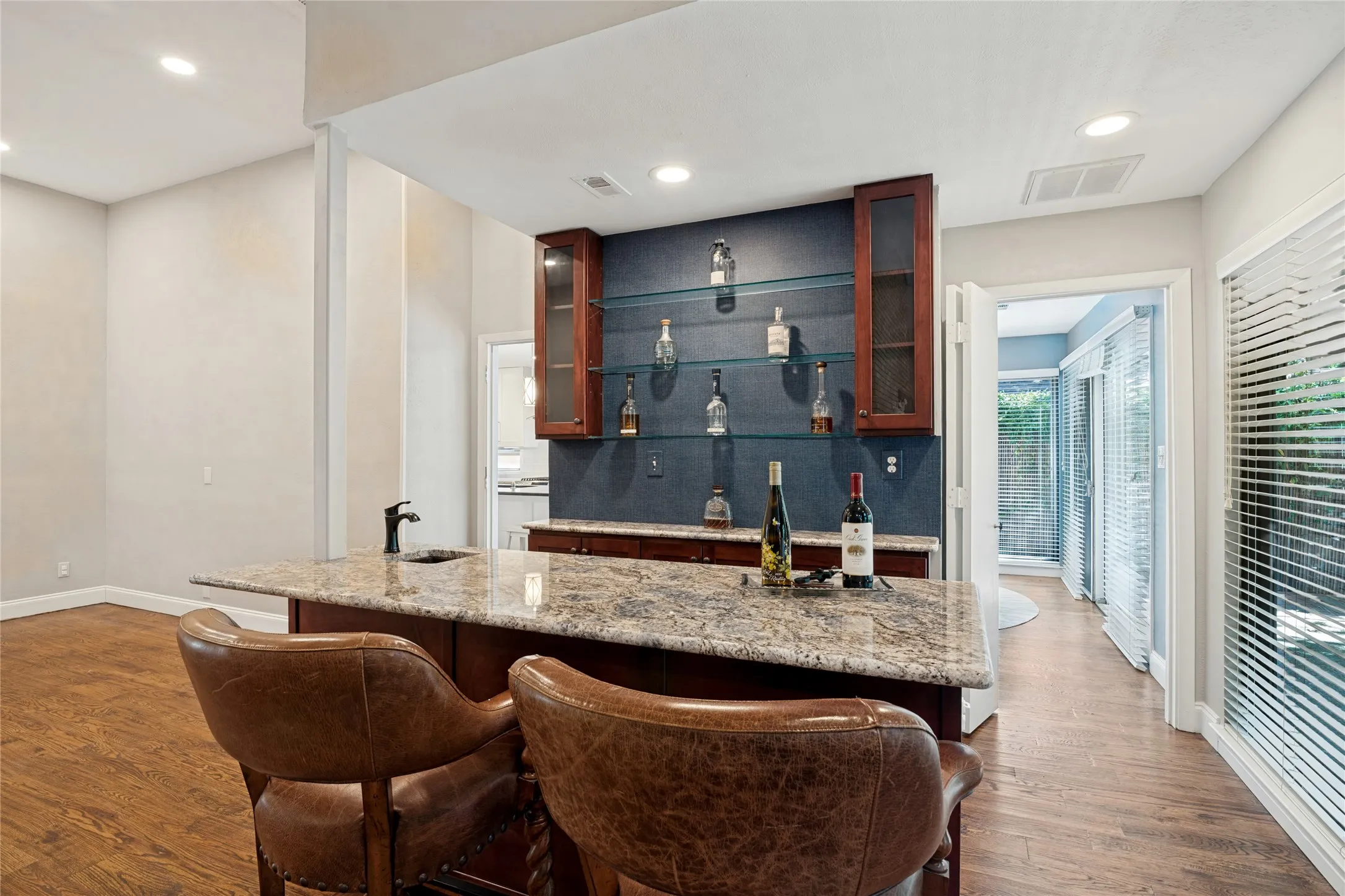 Detail of wet bar with storage and seating.