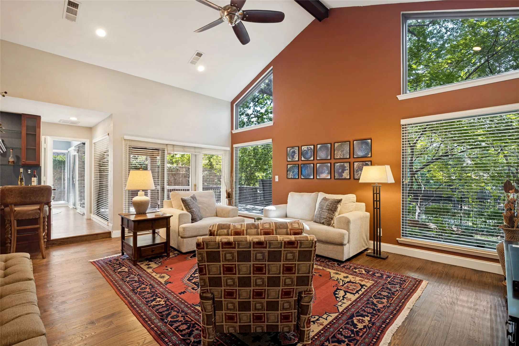 Another view of the Living Room showing the wet bar and access to patio/deck from glass doors.  Kitchen is beyond.