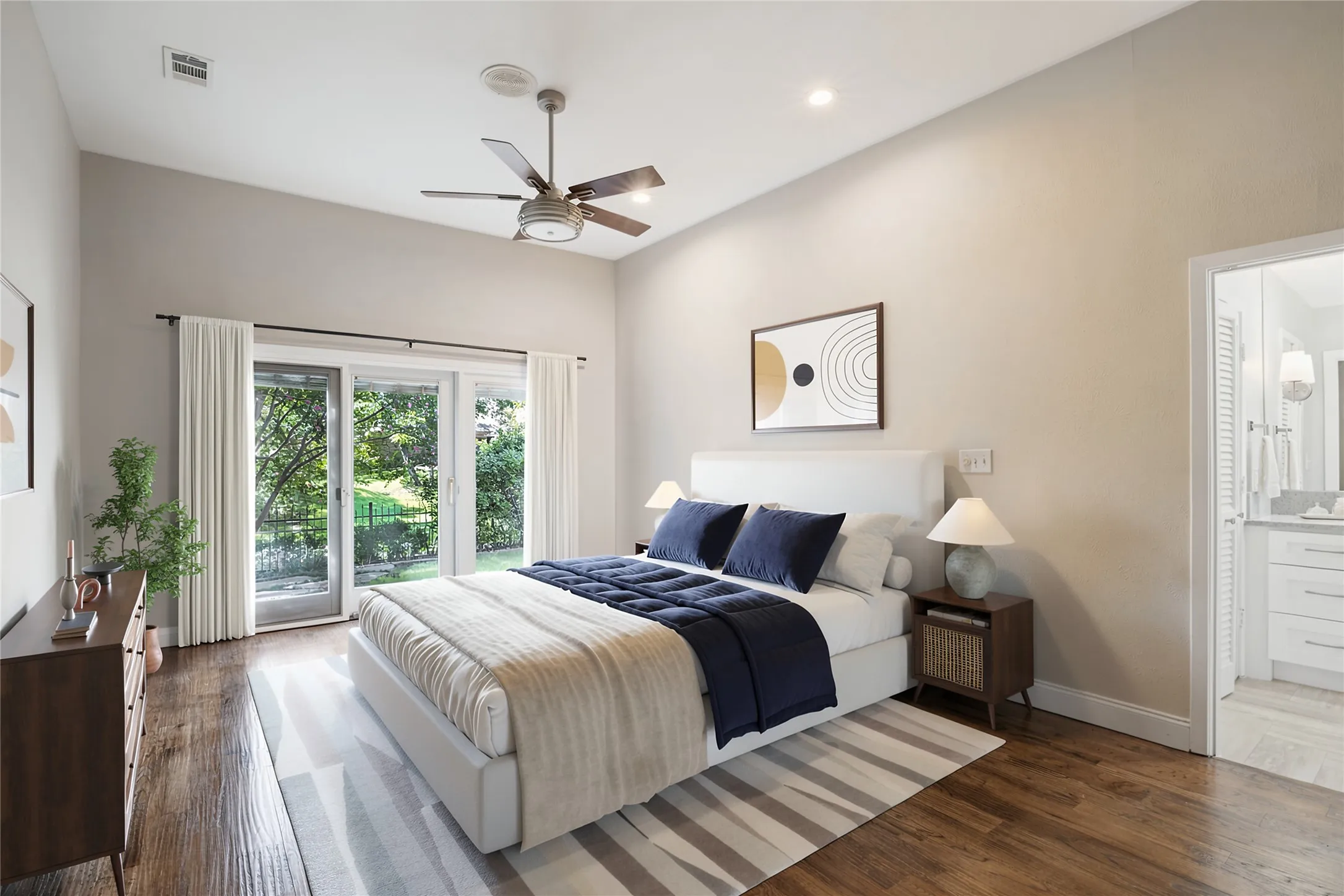 The Primary Bedroom offers direct access to the backyard and lush views.