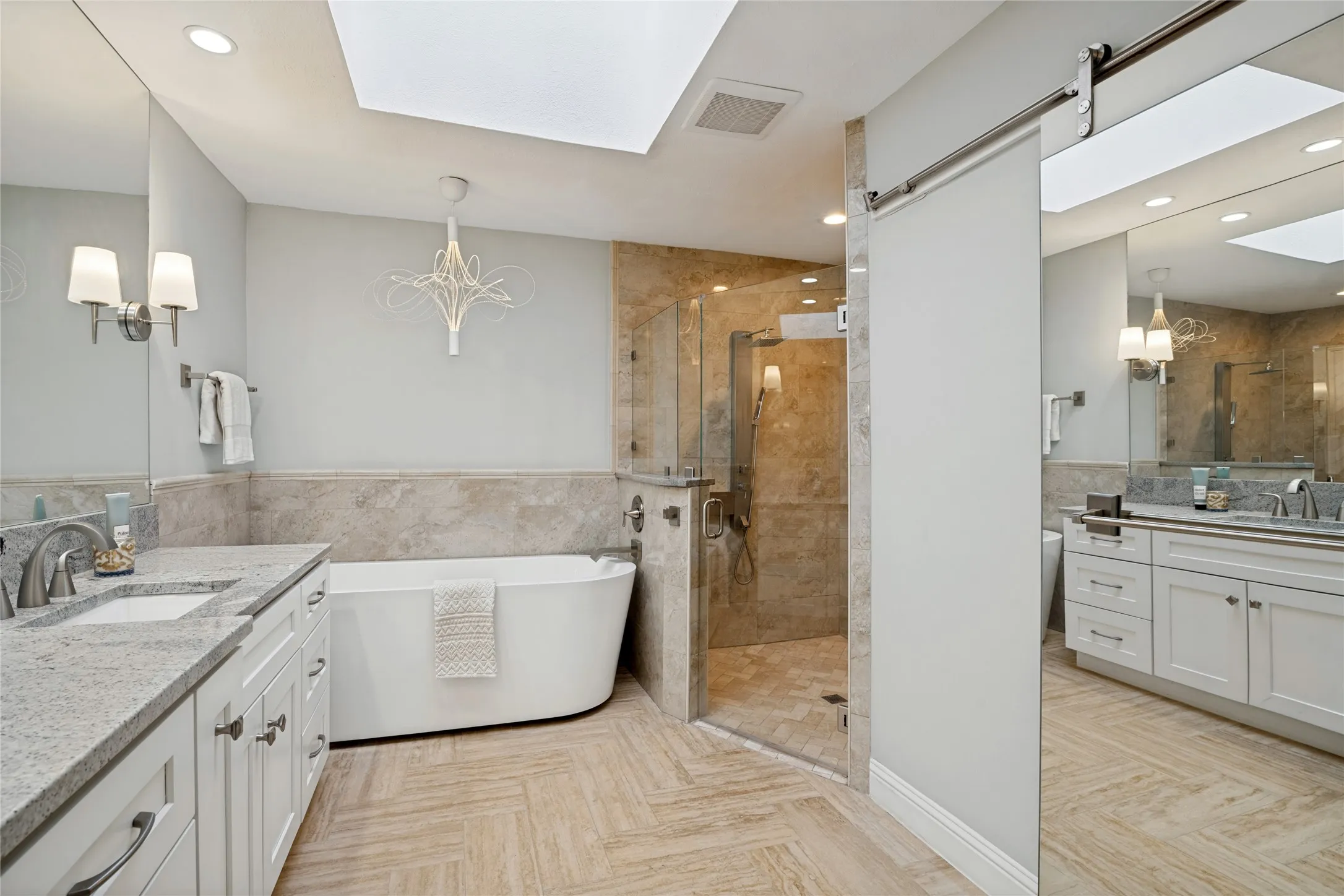 View of the shower, plus the private commode room to the right with a mirrored rolling door for privacy.