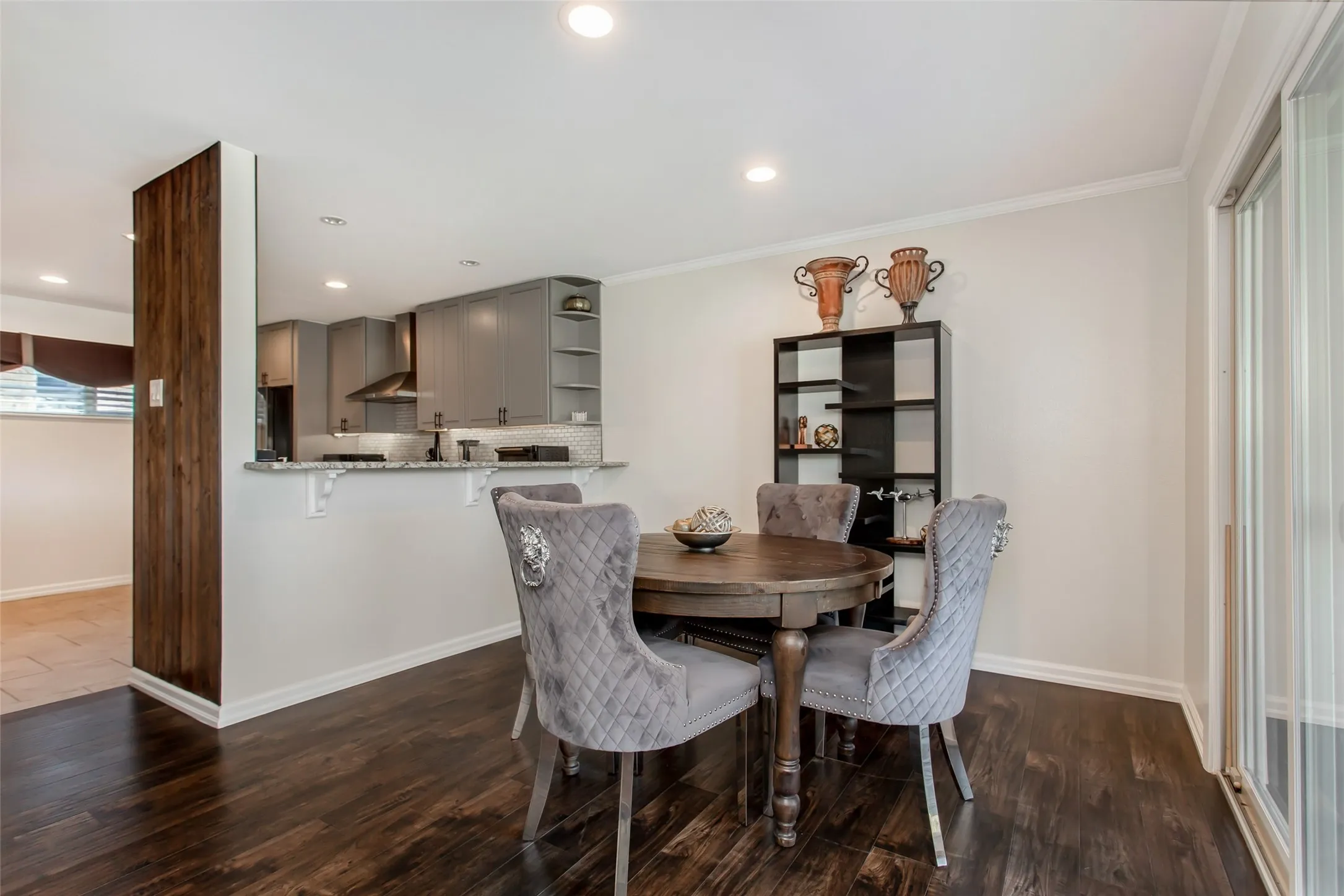 Dark wood-finish flooring, recessed lighting, and crown molding