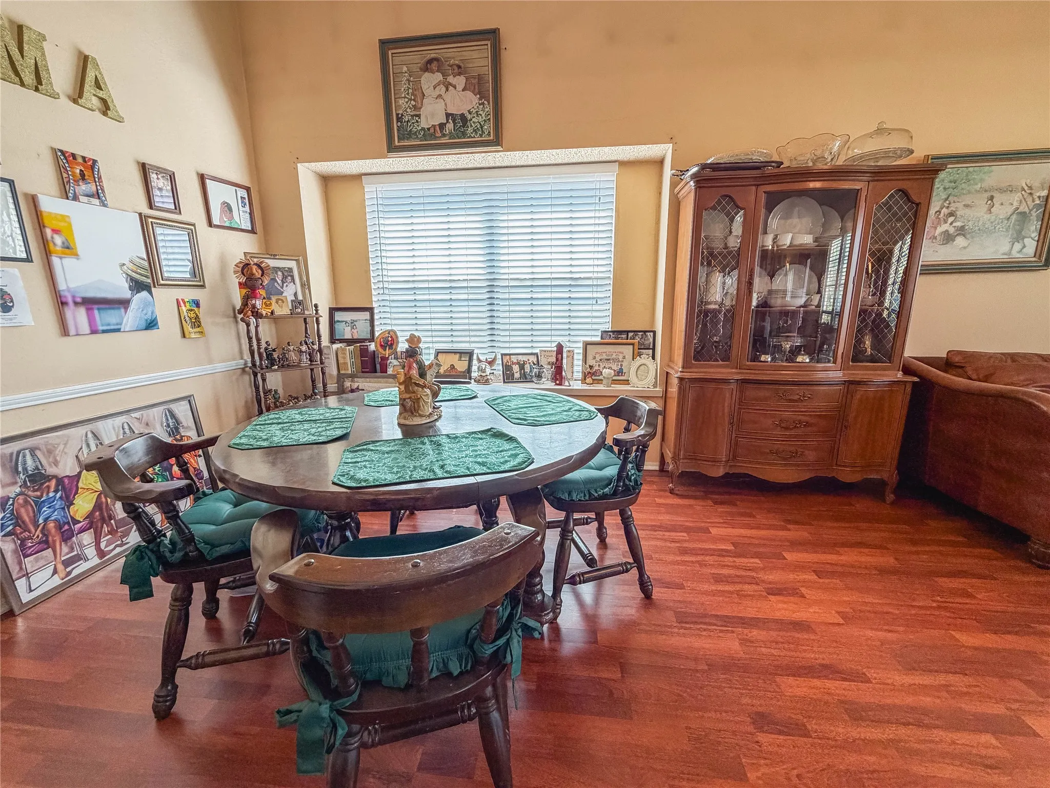 Wood-finish flooring throughout, featuring a built-in window and a glass-front display cabinet