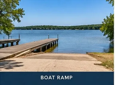 Concrete boat ramp with direct lake access and adjacent boat docks