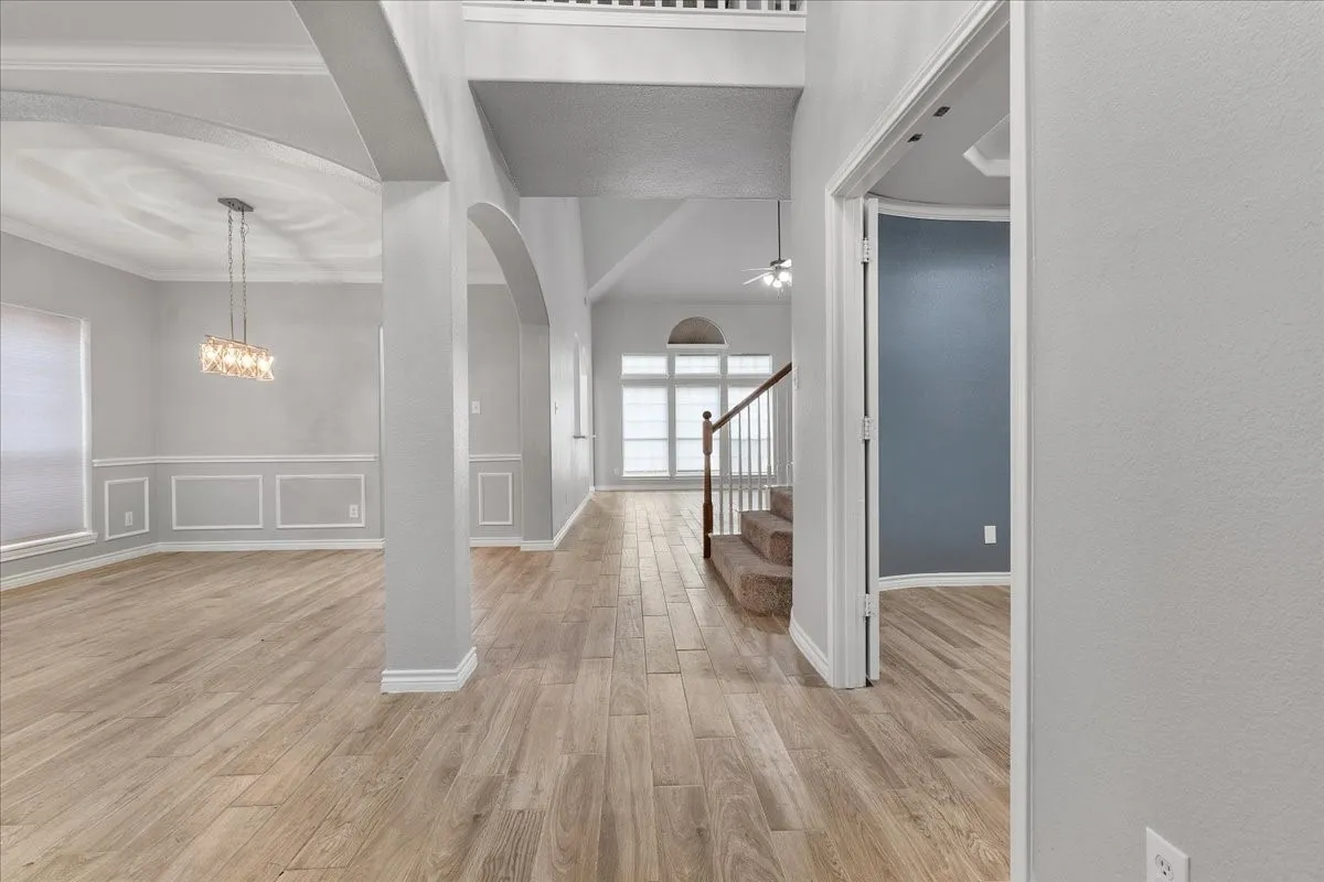 Spacious open-concept interior featuring wood-finish flooring throughout the main level
