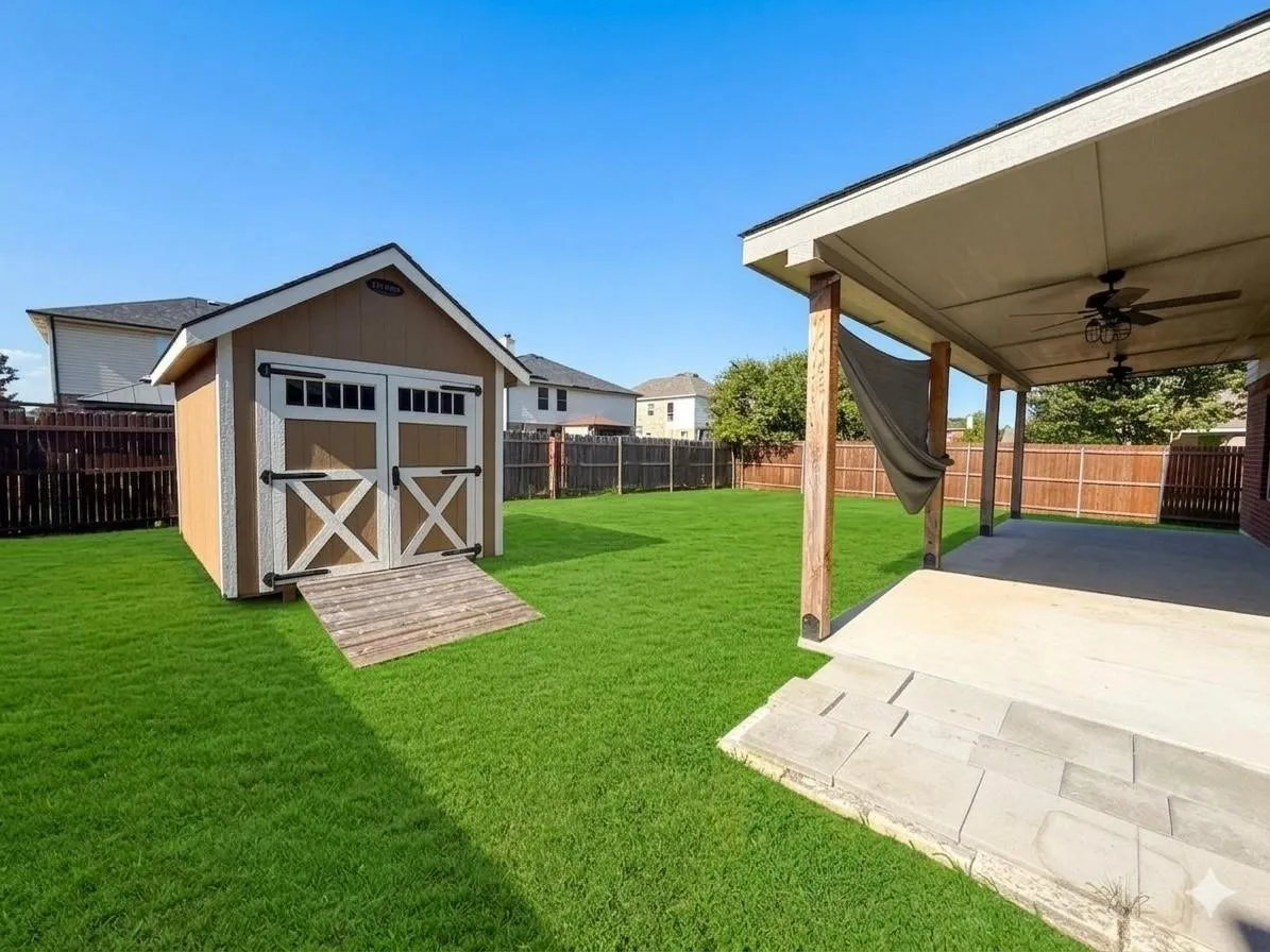 Expansive green lawn featuring a storage shed with double doors and a wood ramp
