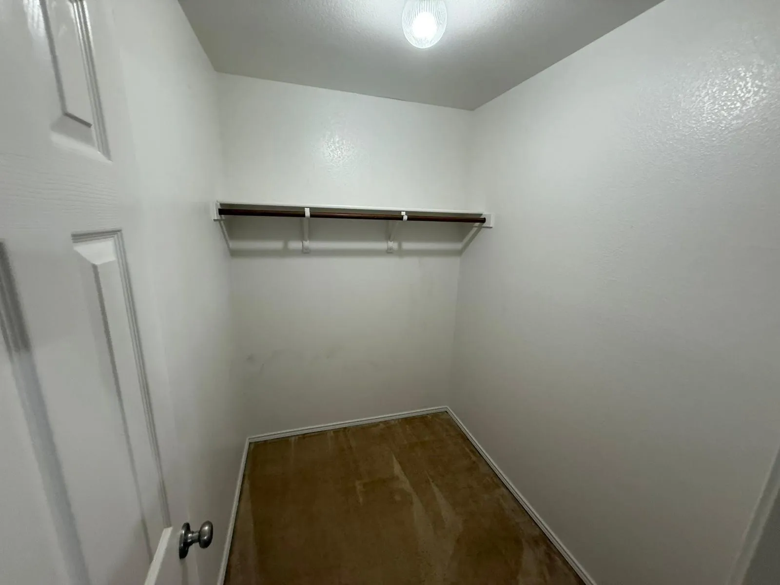 Recessed hanging rod with upper shelf and carpet flooring