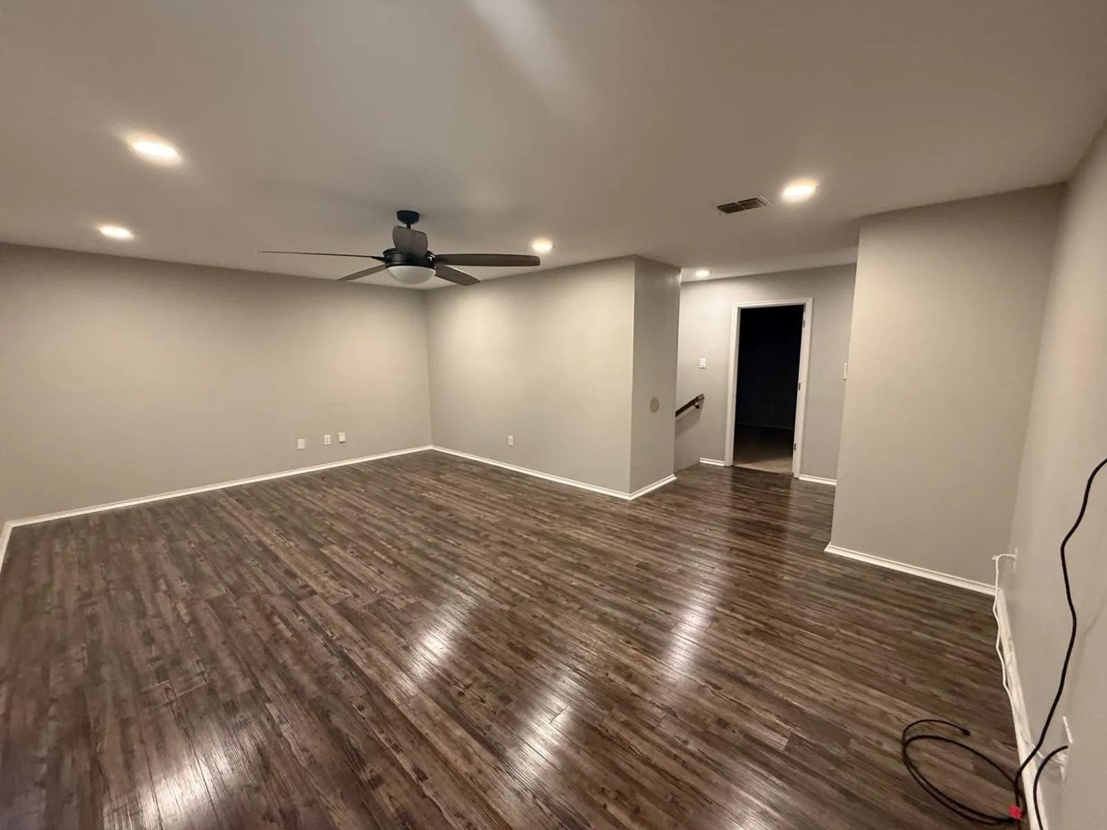 Recessed lighting, wood-finish flooring, ceiling fan, neutral wall tones, and white trim