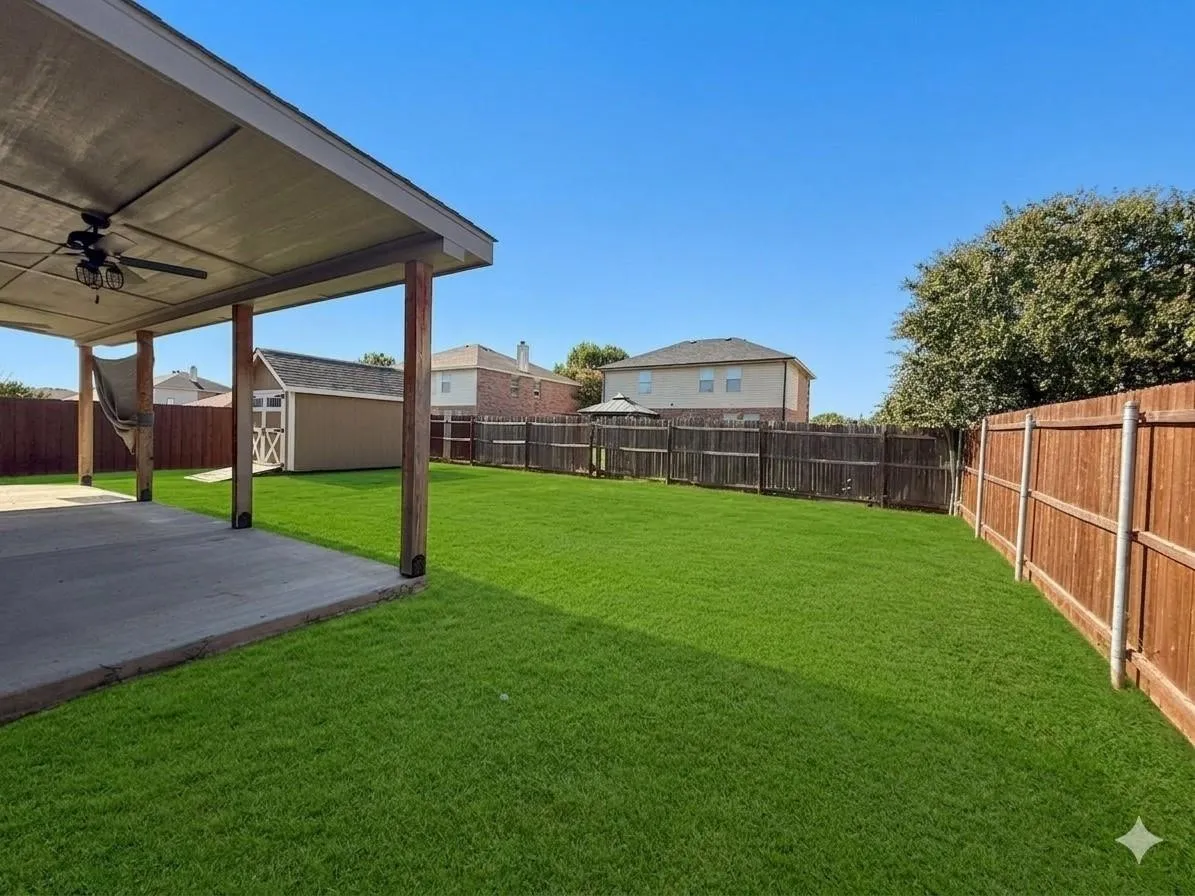 Expansive lawn with wood fencing