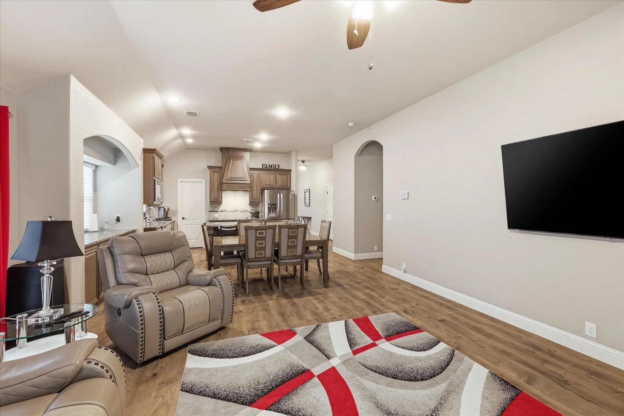 Open concept living area featuring wood-finish flooring