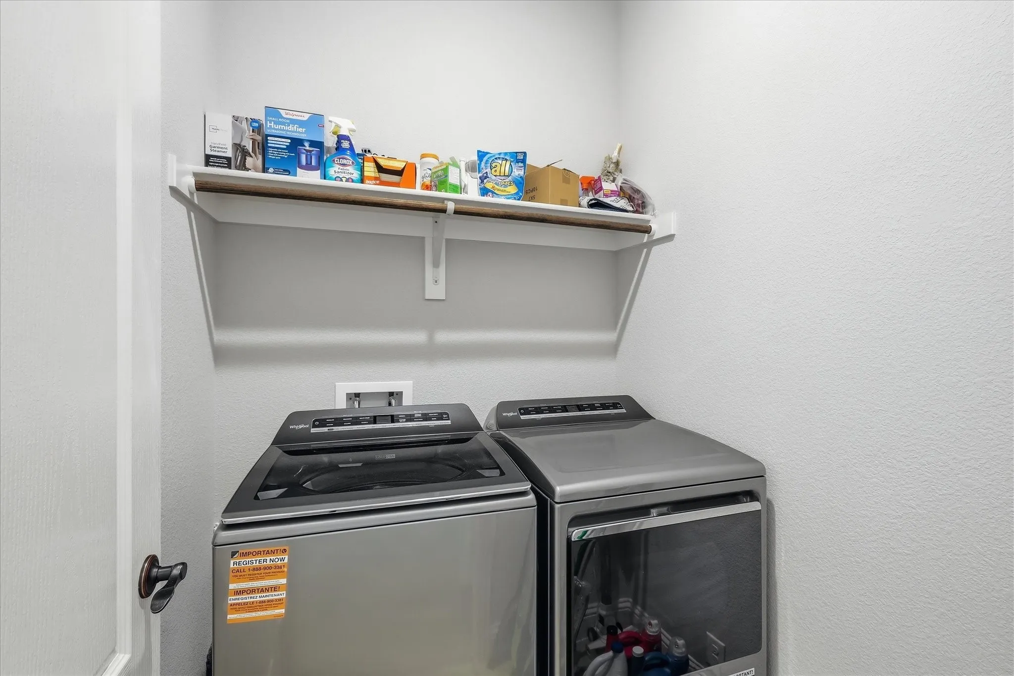 Wall-mounted shelving with integrated hanging rod