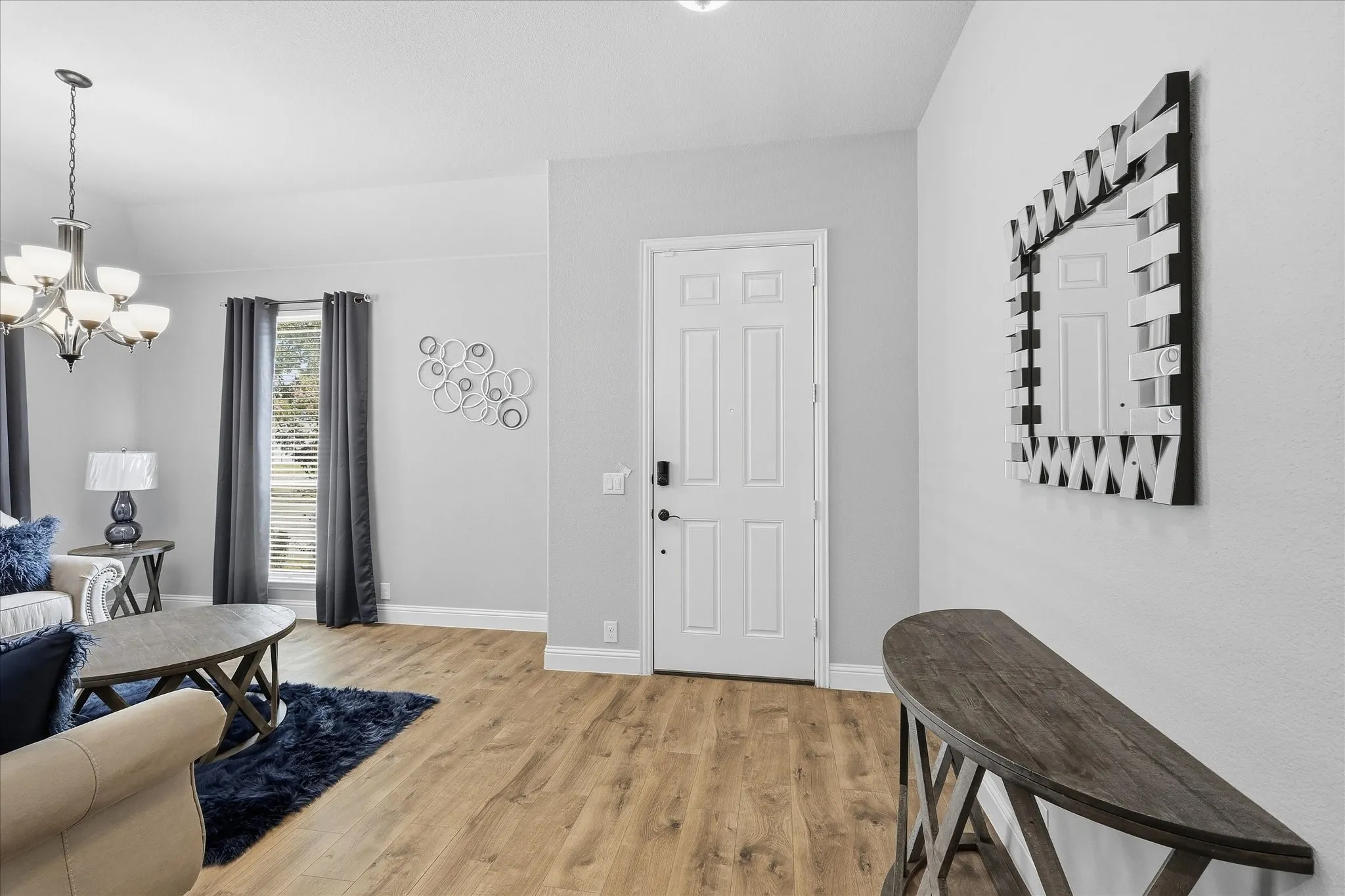 Wood-finish flooring throughout, complemented by a white paneled door