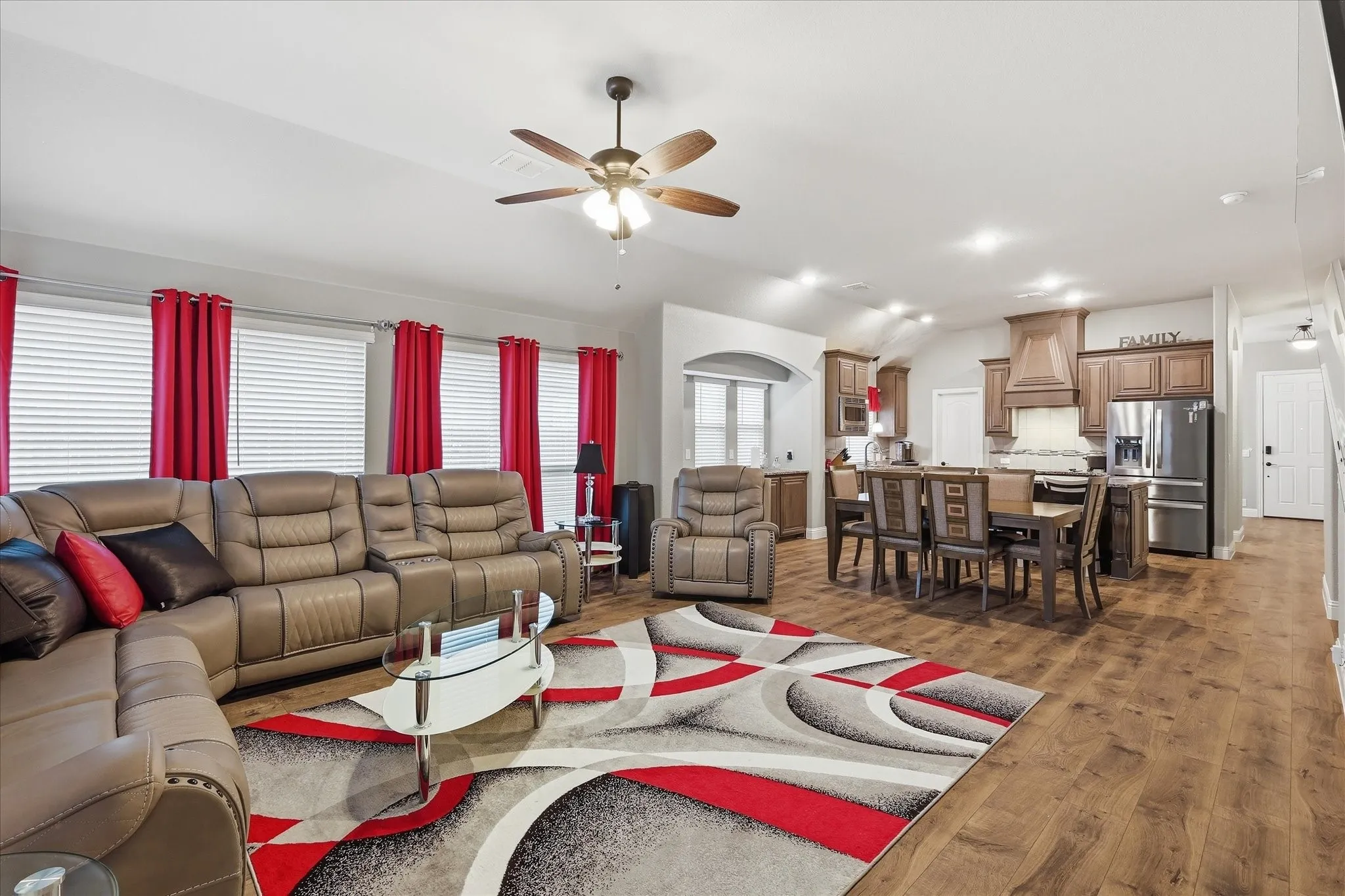 Open-concept living space featuring wood-finish flooring, recessed lighting, and a ceiling fan