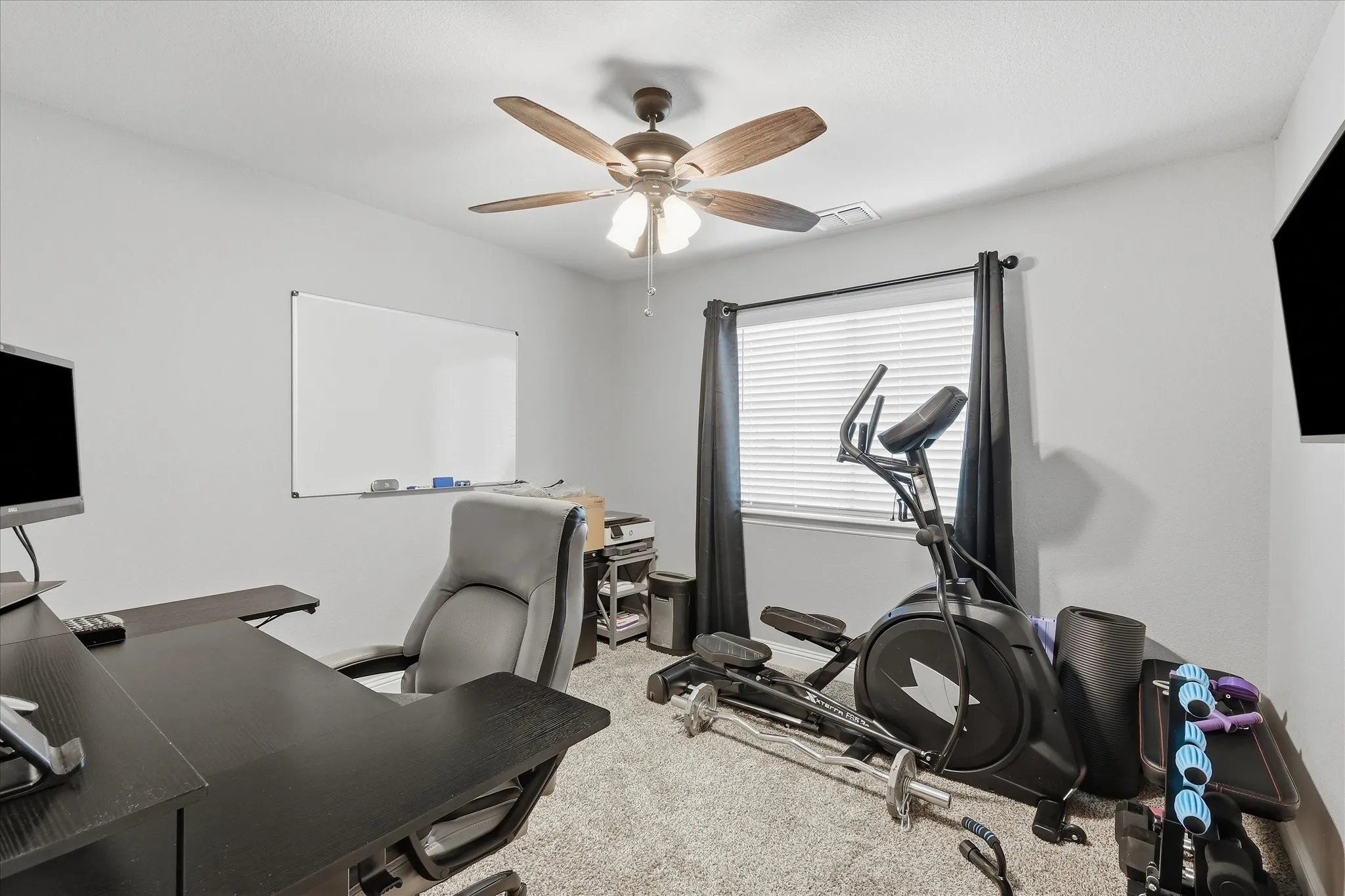 Neutral wall color, ceiling fan, window with blinds, and carpeted flooring