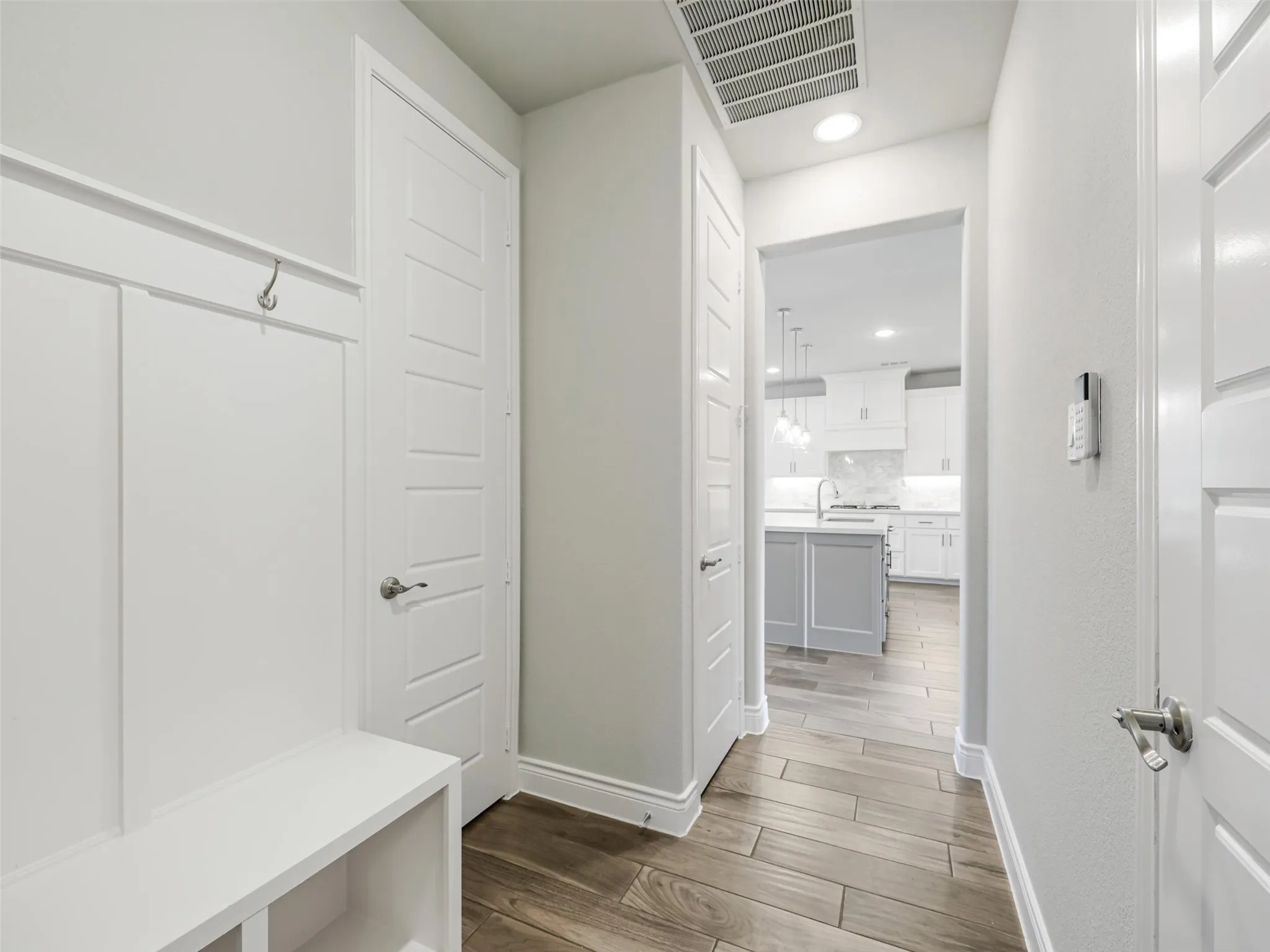 Practical details have been incorporated throughout the home's design. A dedicated mud room with built-in storage provides an organized transition area for shoes, bags, and everyday essentials.