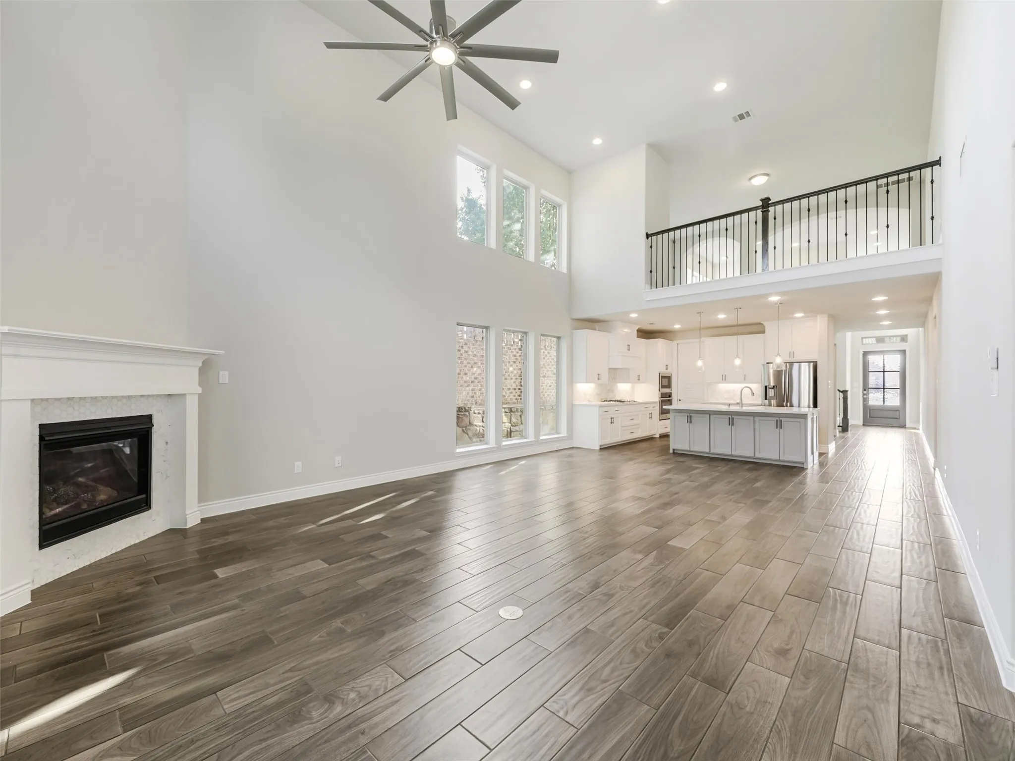A corner fireplace provides an inviting focal point and creates a warm atmosphere for relaxing or gathering with family and friends. The open-concept design allows the kitchen, dining, and living spaces to flow naturally together while still maintaining their individual character.