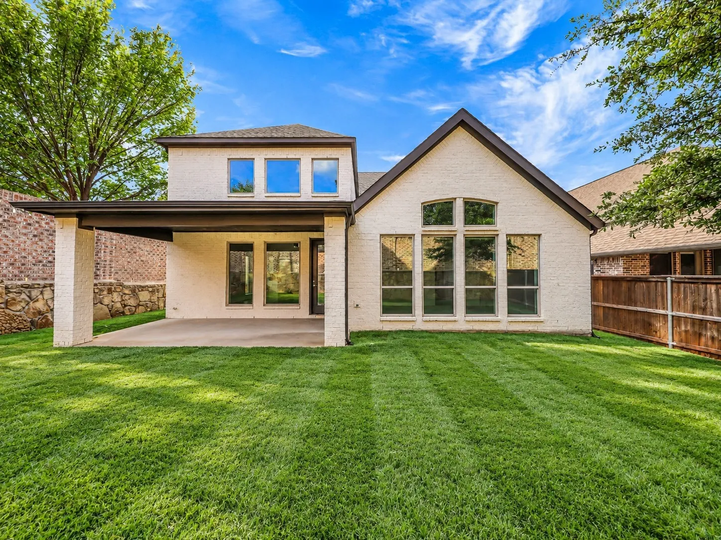 Spacious backyard with covered patio.
