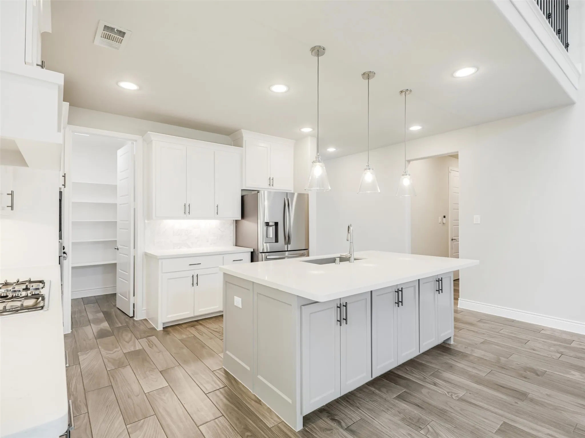 The kitchen opens to the impressive living room, where a soaring cathedral ceiling adds volume and architectural interest.