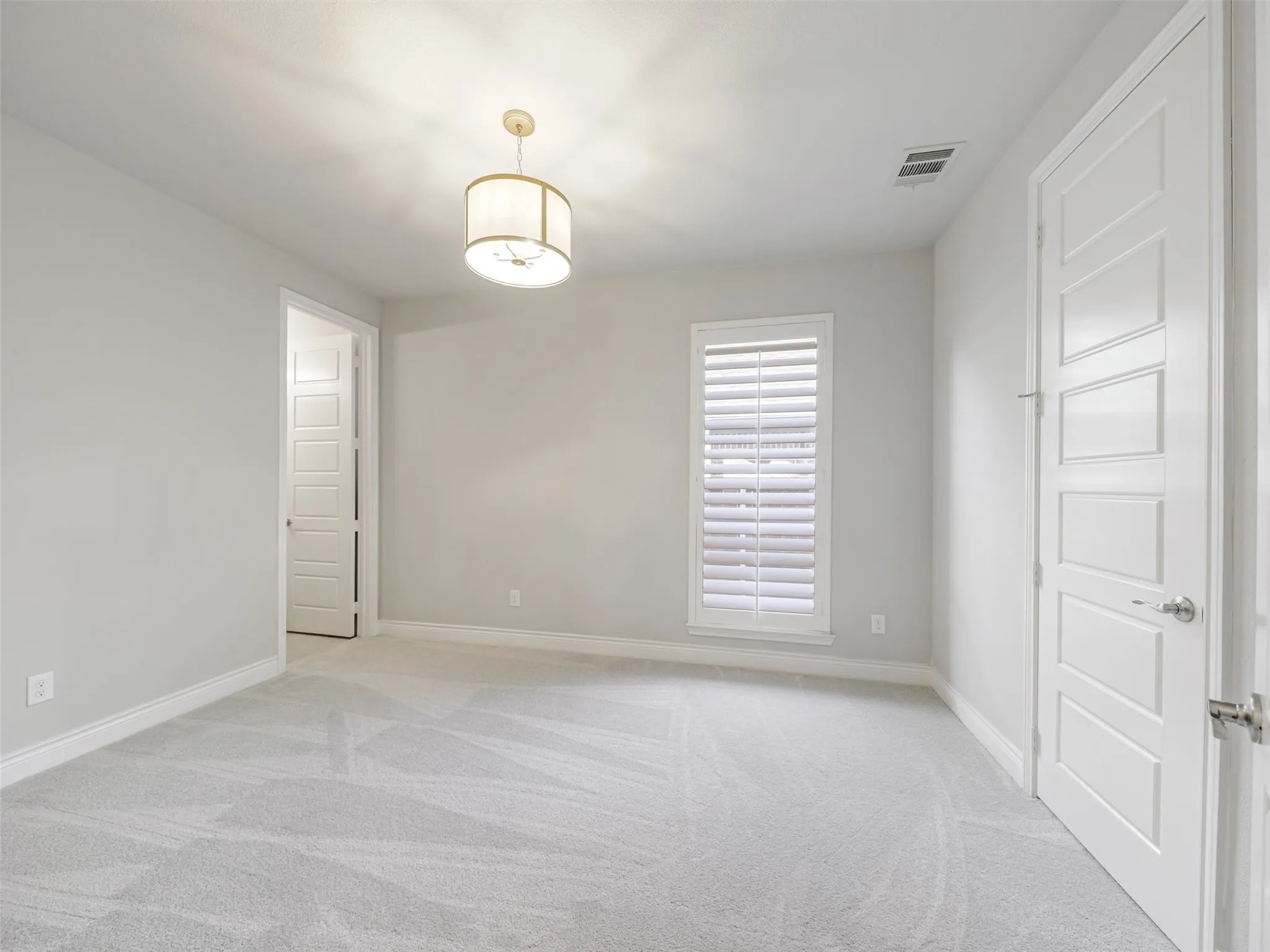 A secondary bedroom located on the first floor offers additional flexibility and privacy. Complete with its own walk-in closet and private ensuite bathroom, this space is well suited for overnight guests, extended stays, or a private secondary suite.