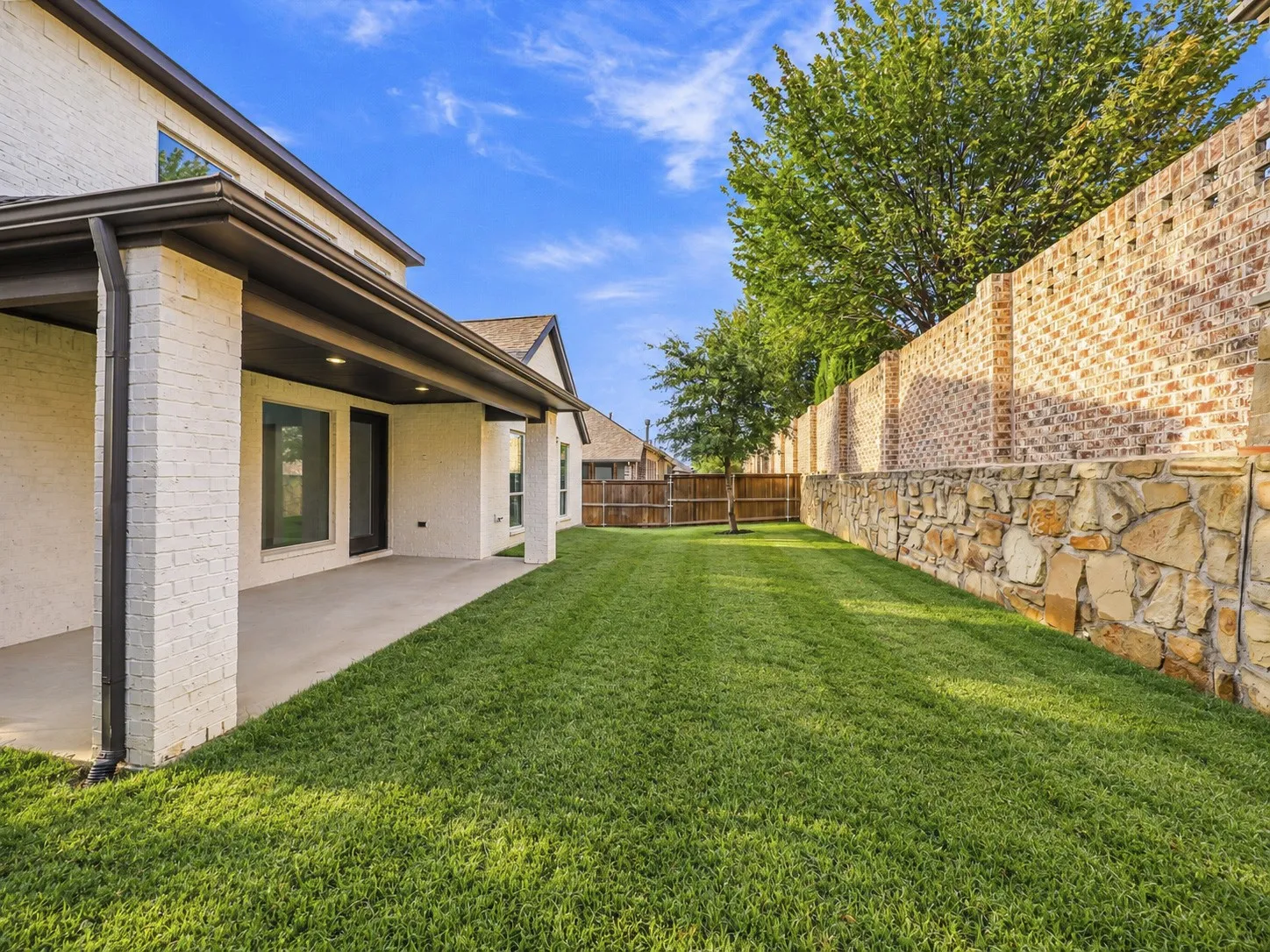 Spacious backyard with covered patio.