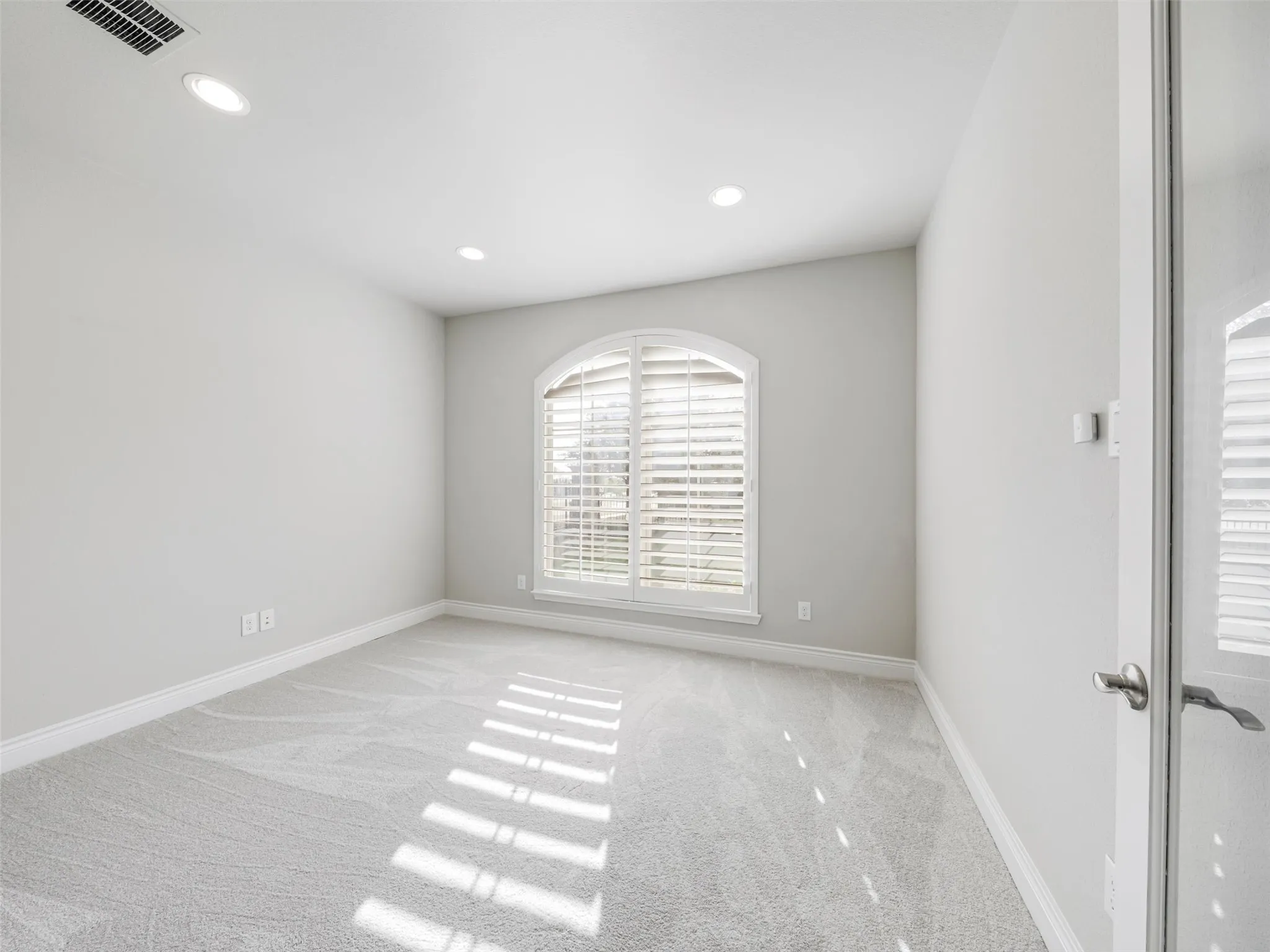 Office with arched windows and french doors are ready for working from home.
