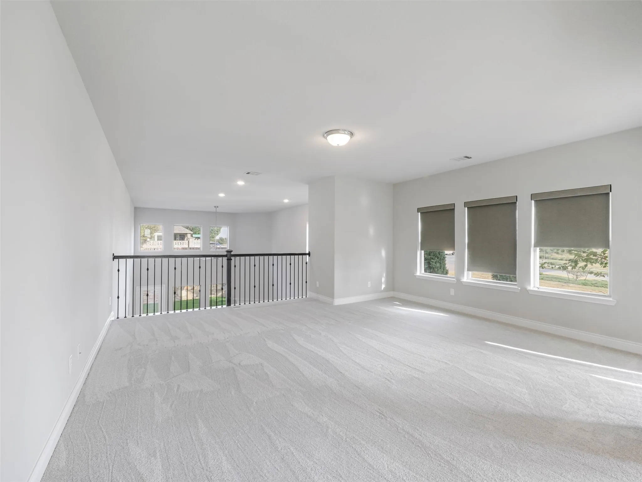 The game room provides a versatile area for recreation, movies, hobbies, or an additional lounge. A balcony overlooking the living room below enhances the home's open design and provides a dramatic view of the cathedral ceiling and main gathering space.