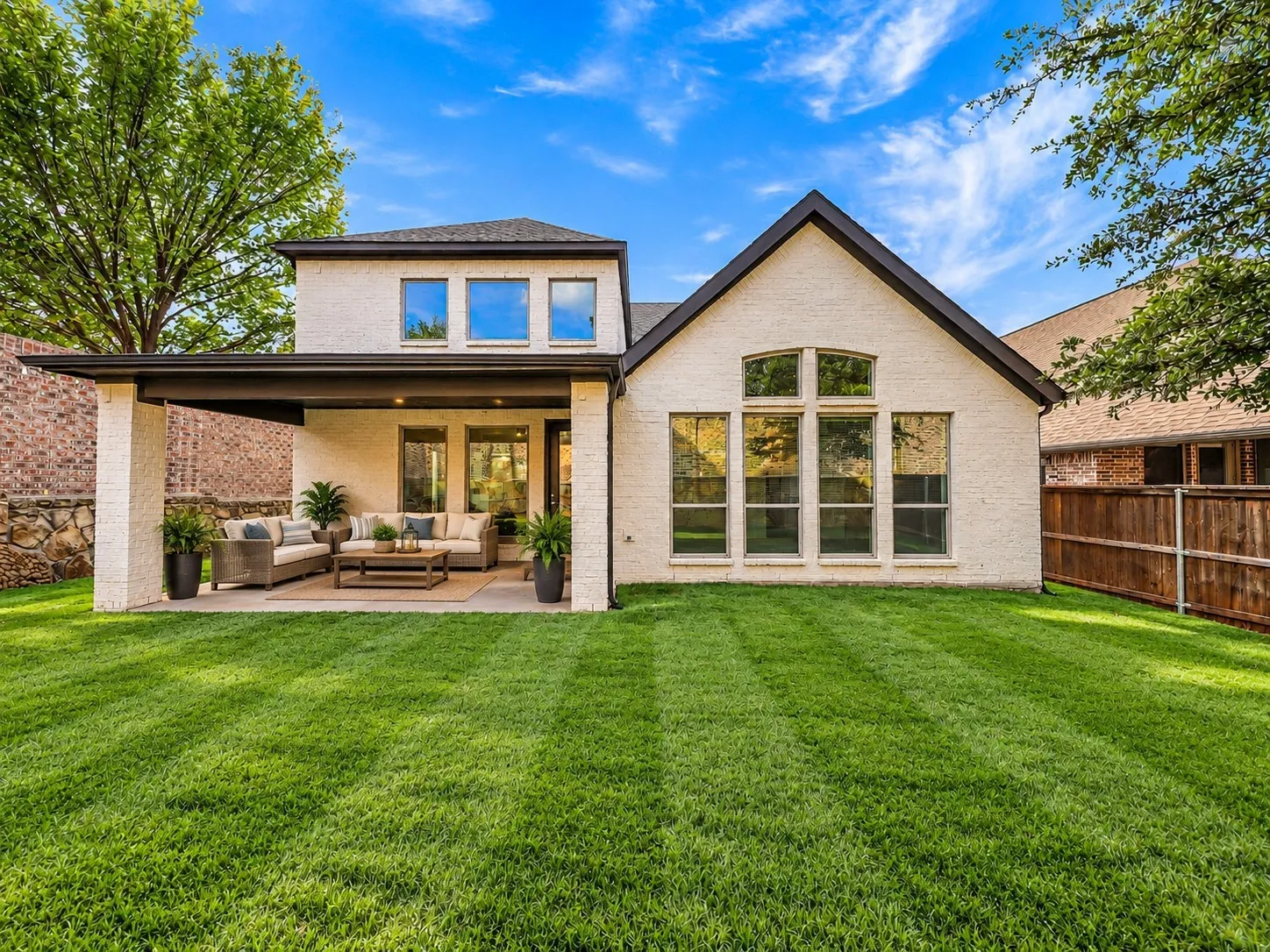 Virtually Staged. Spacious fenced backyard with covered patio. Privacy brick fence.