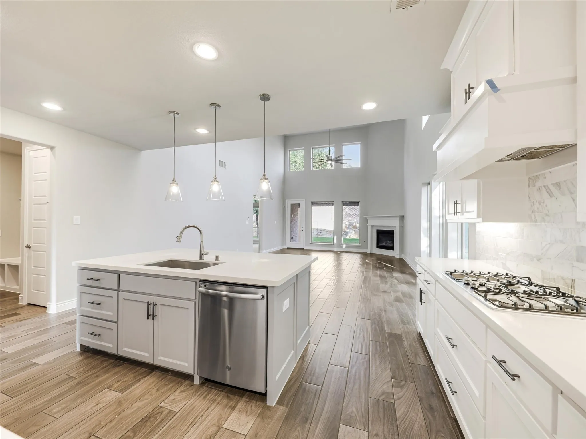 The kitchen opens to the impressive living room, where a soaring cathedral ceiling adds volume and architectural interest.