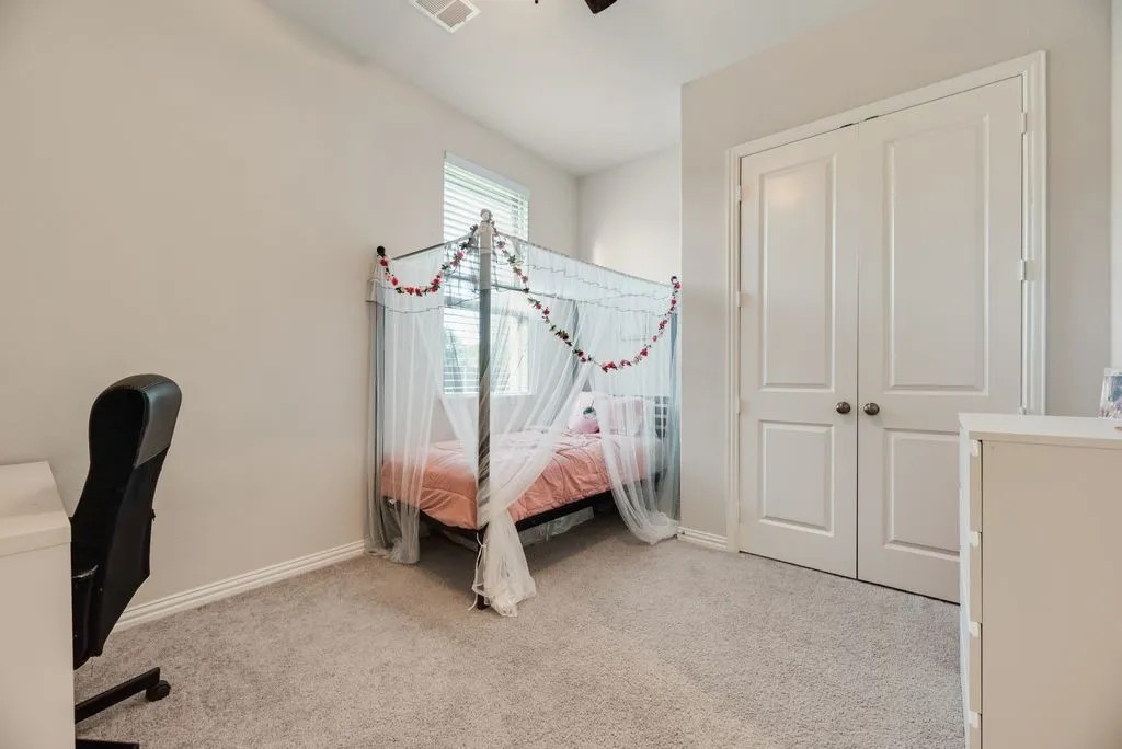Recessed window with horizontal blinds, neutral wall paint, and gray carpet flooring