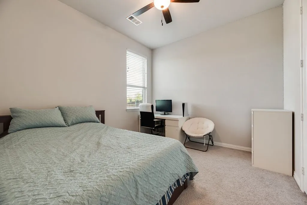 Neutral paint palette with sloped ceilings and a ceiling fan