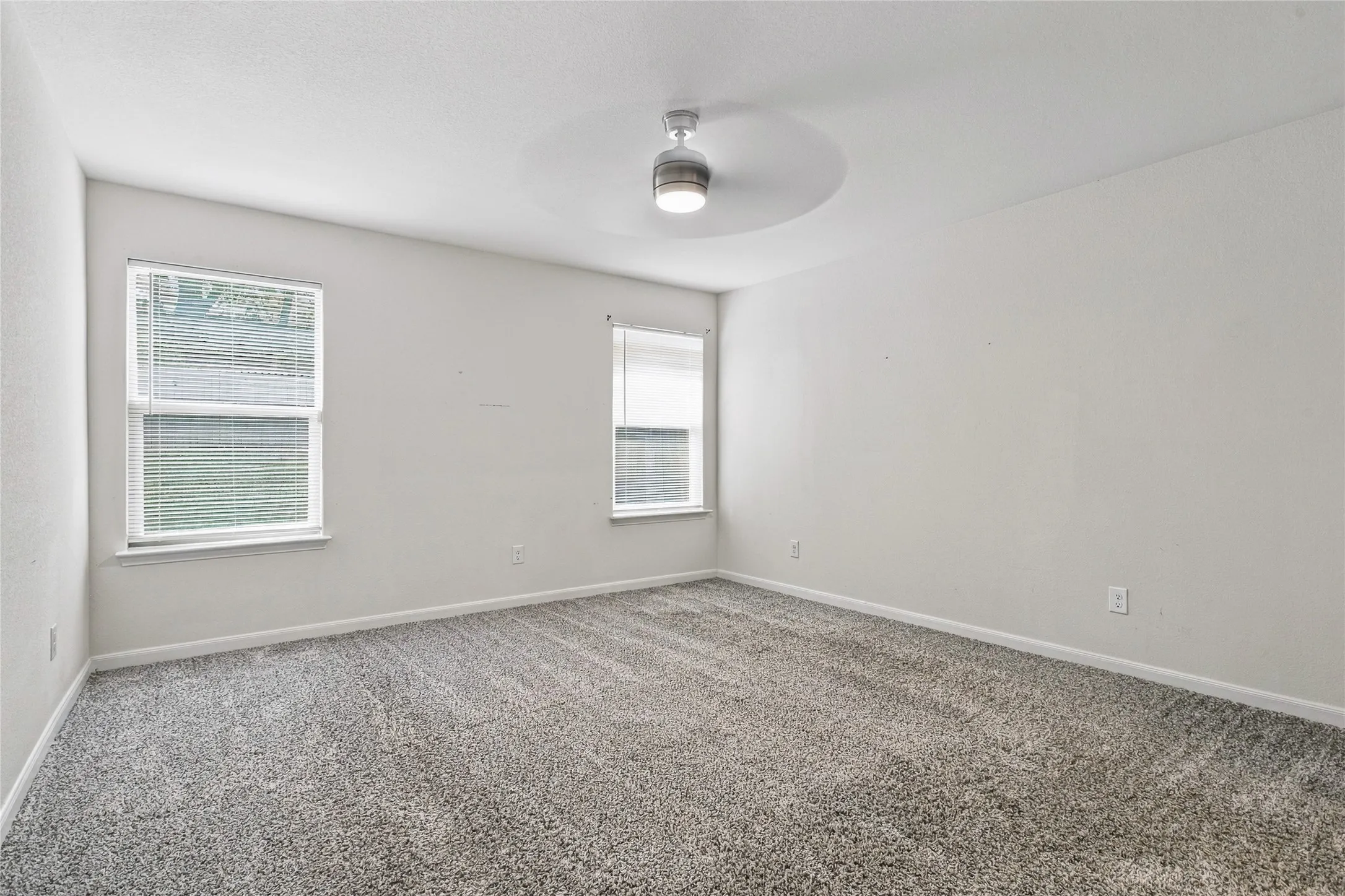 View of the Primary Bedroom with Backyard-Facing Windows that allow for plenty of Natural Light