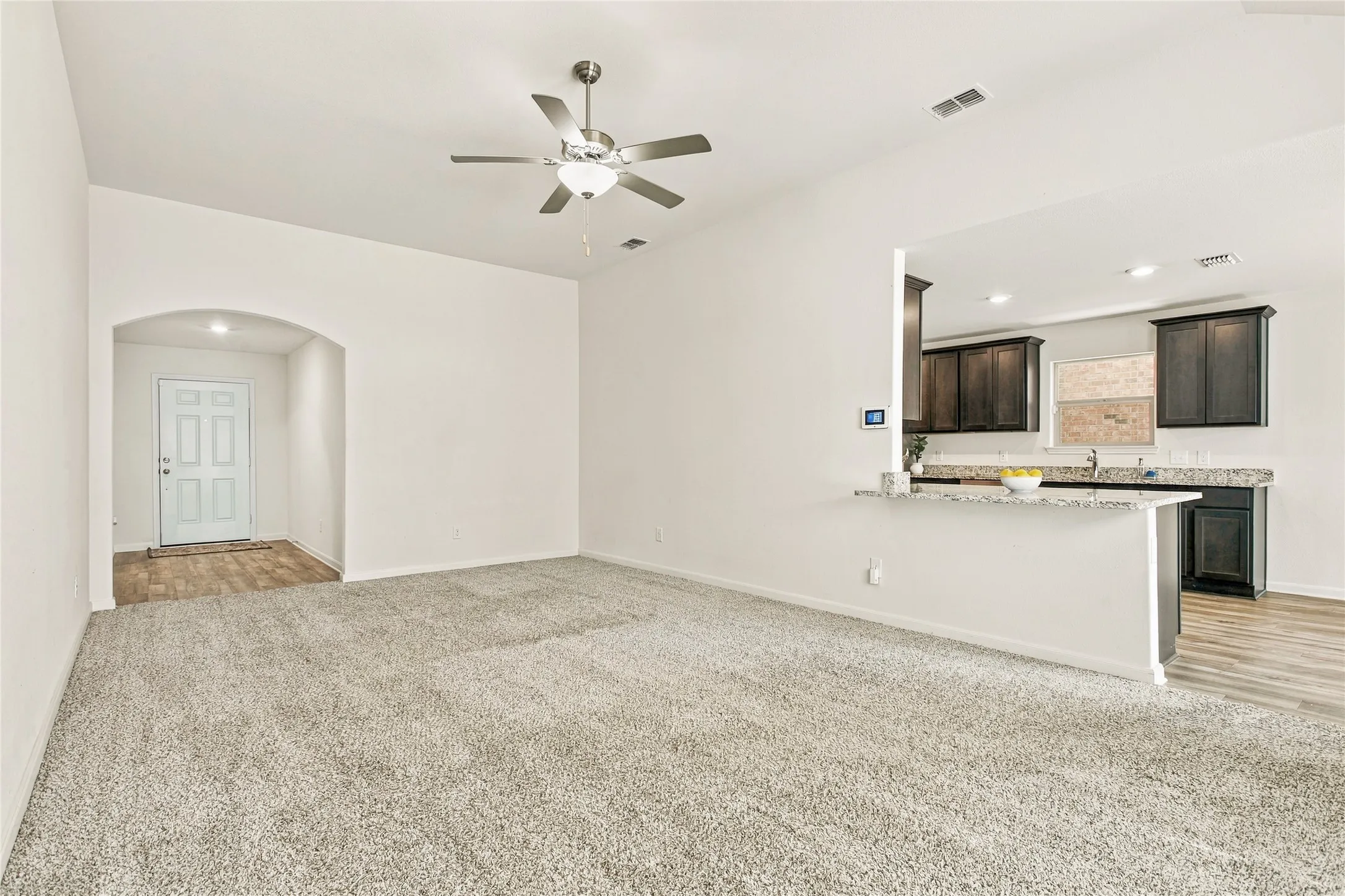 View of the Open Concept Living Room leading into the Kitchen
