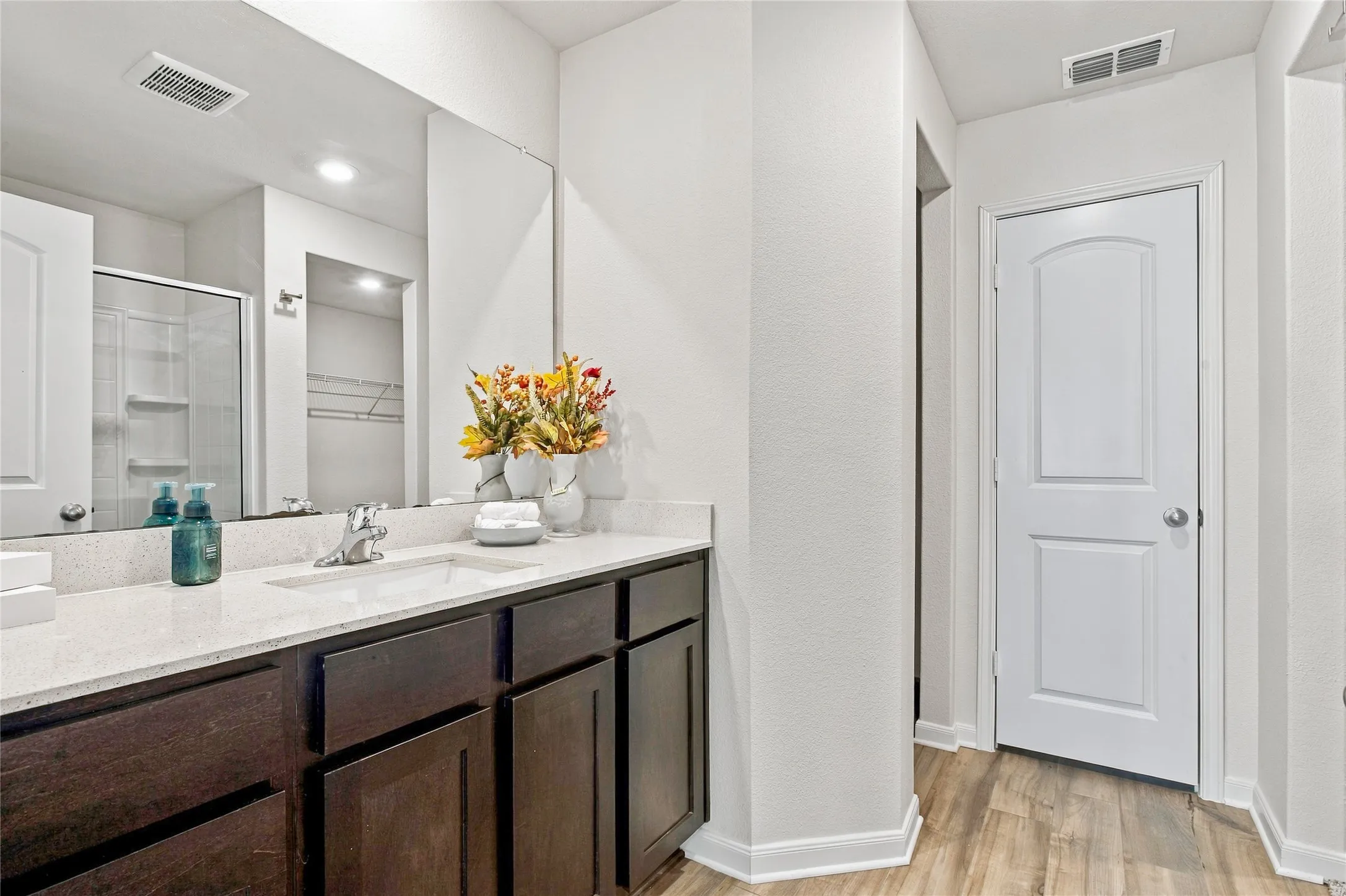 View of the Spacious Primary Bathroom with Linen Closet and WC