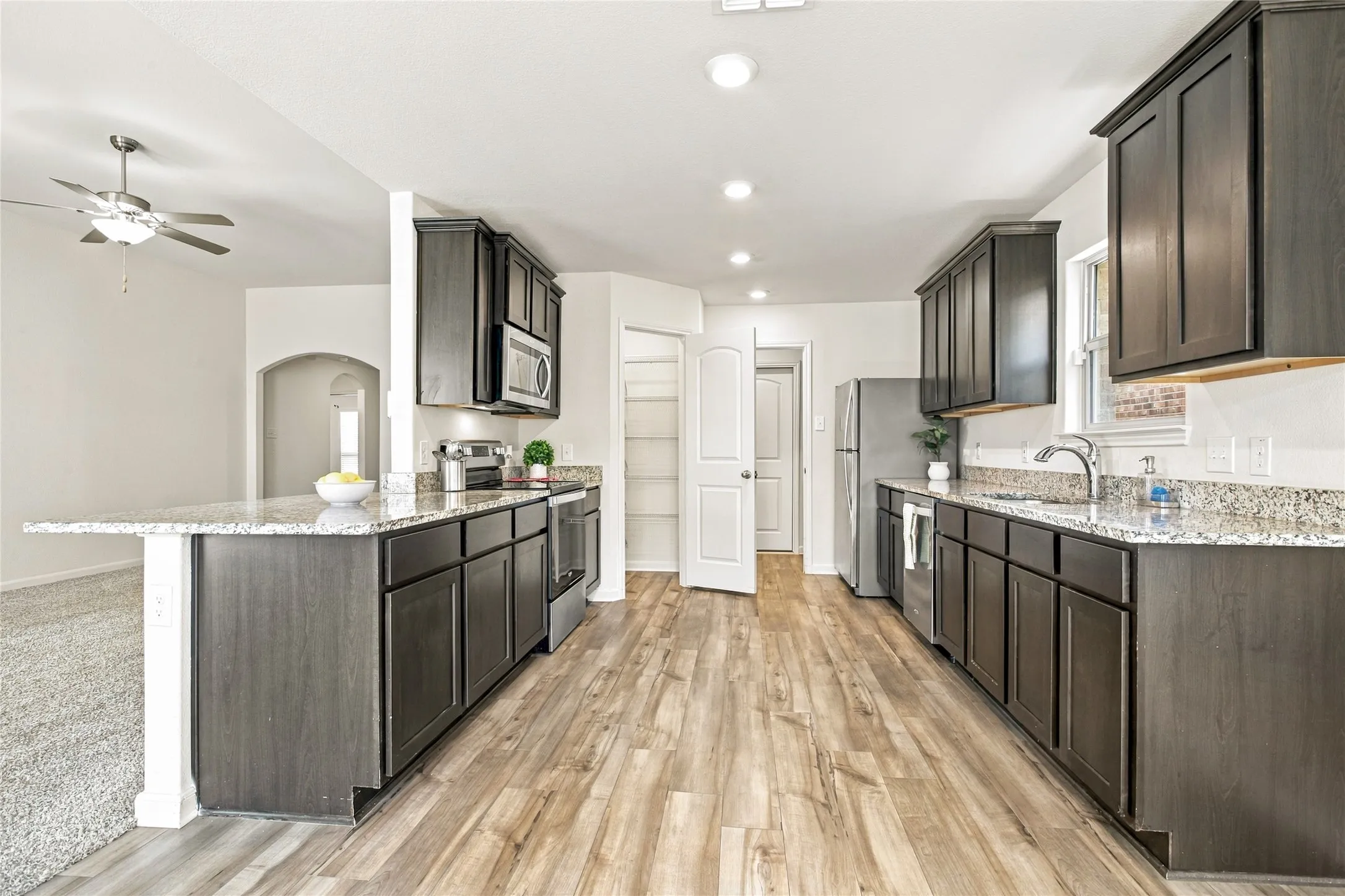 View of the Kitchen with a Large Pantry and the adjoining Laundry Room that leads to the​​‌​​​​‌​​‌‌​‌‌​​​‌‌​‌​‌​‌​​​‌​​ Garage