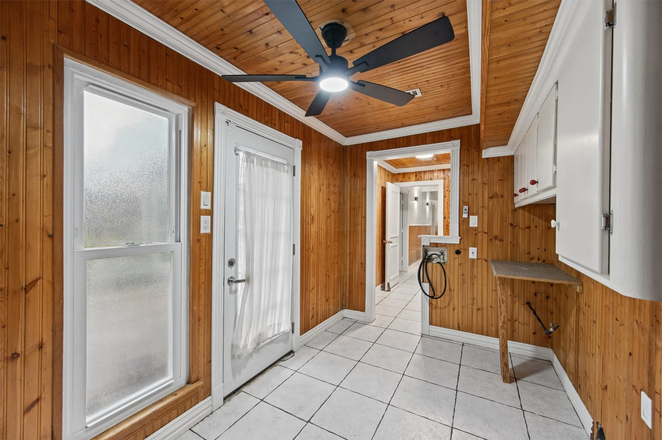 Wood-paneled walls and ceiling with white trim