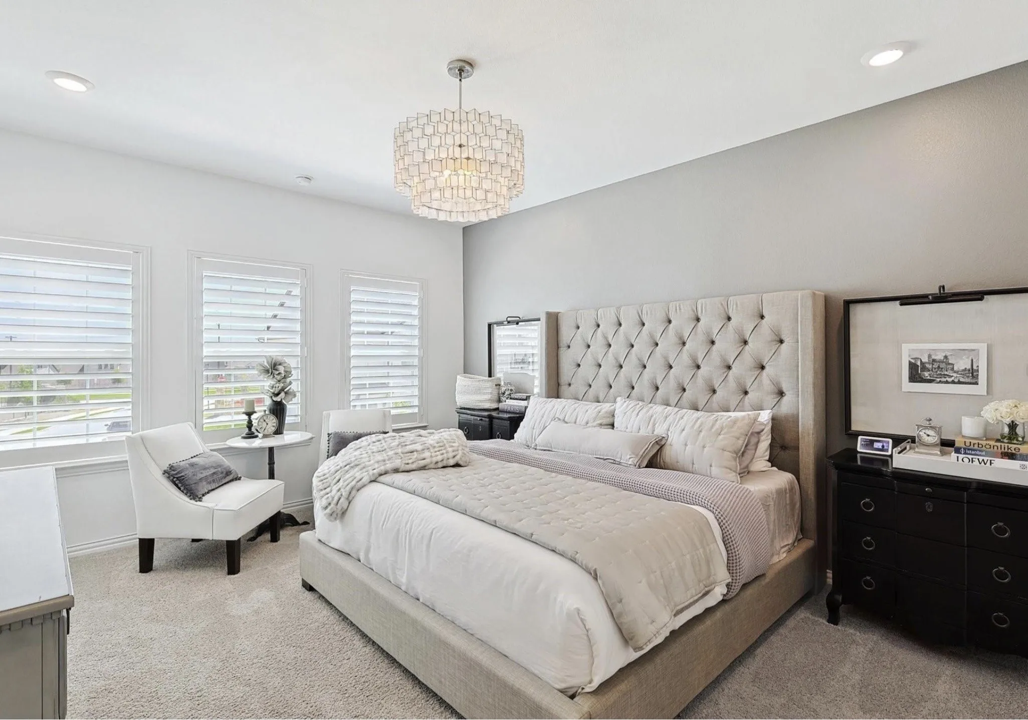 Triple window array with blinds, recessed lighting, and a decorative ceiling fixture