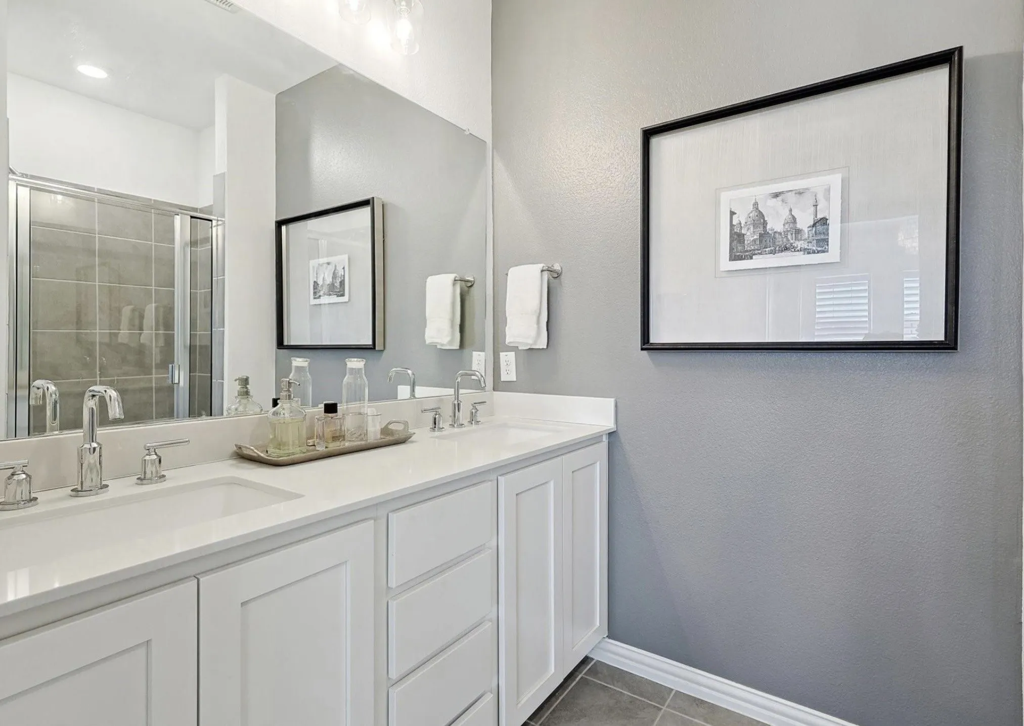 Dual vanity with white cabinetry and integrated sinks