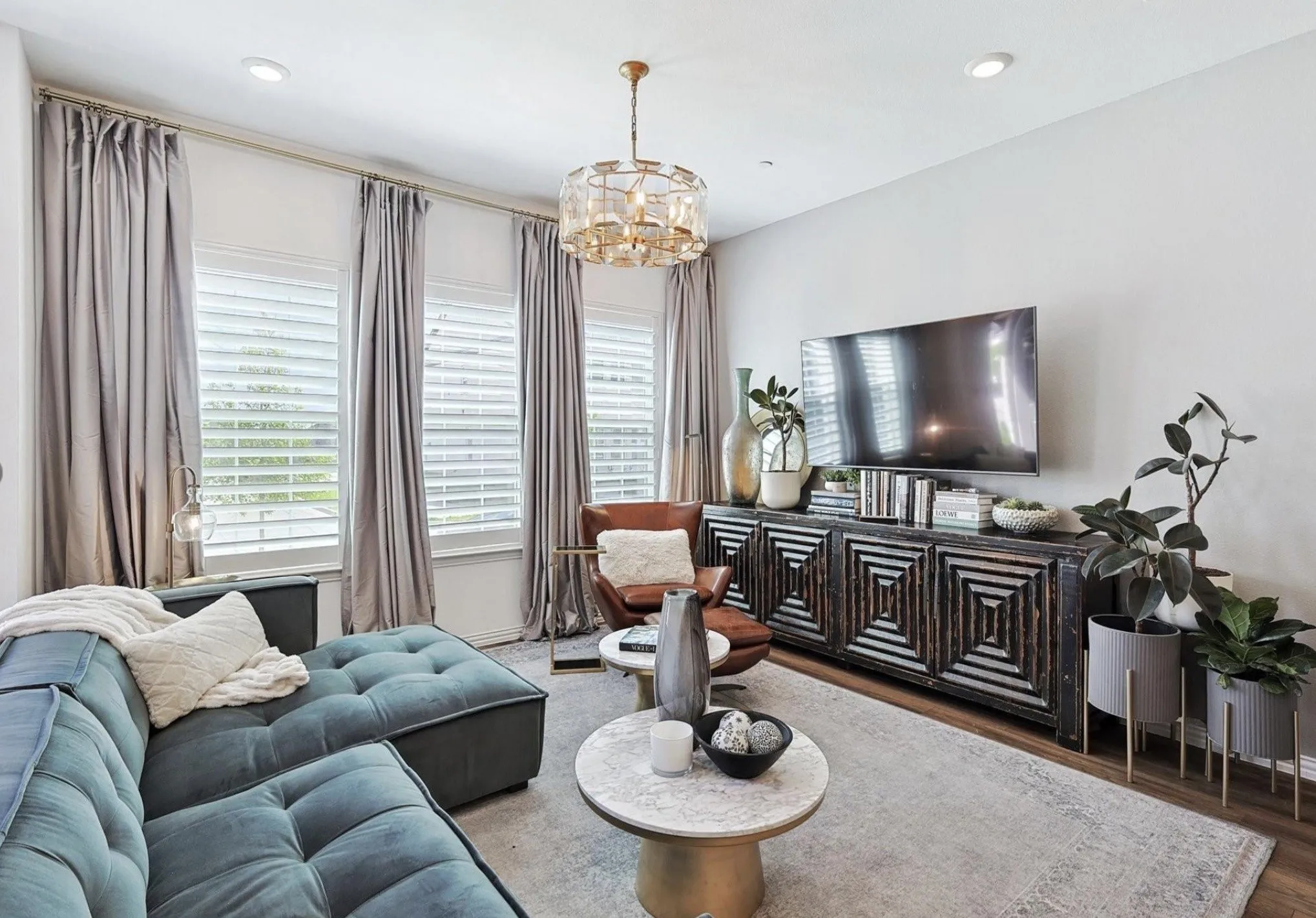 Recessed lighting, wood-finish flooring, and a decorative chandelier