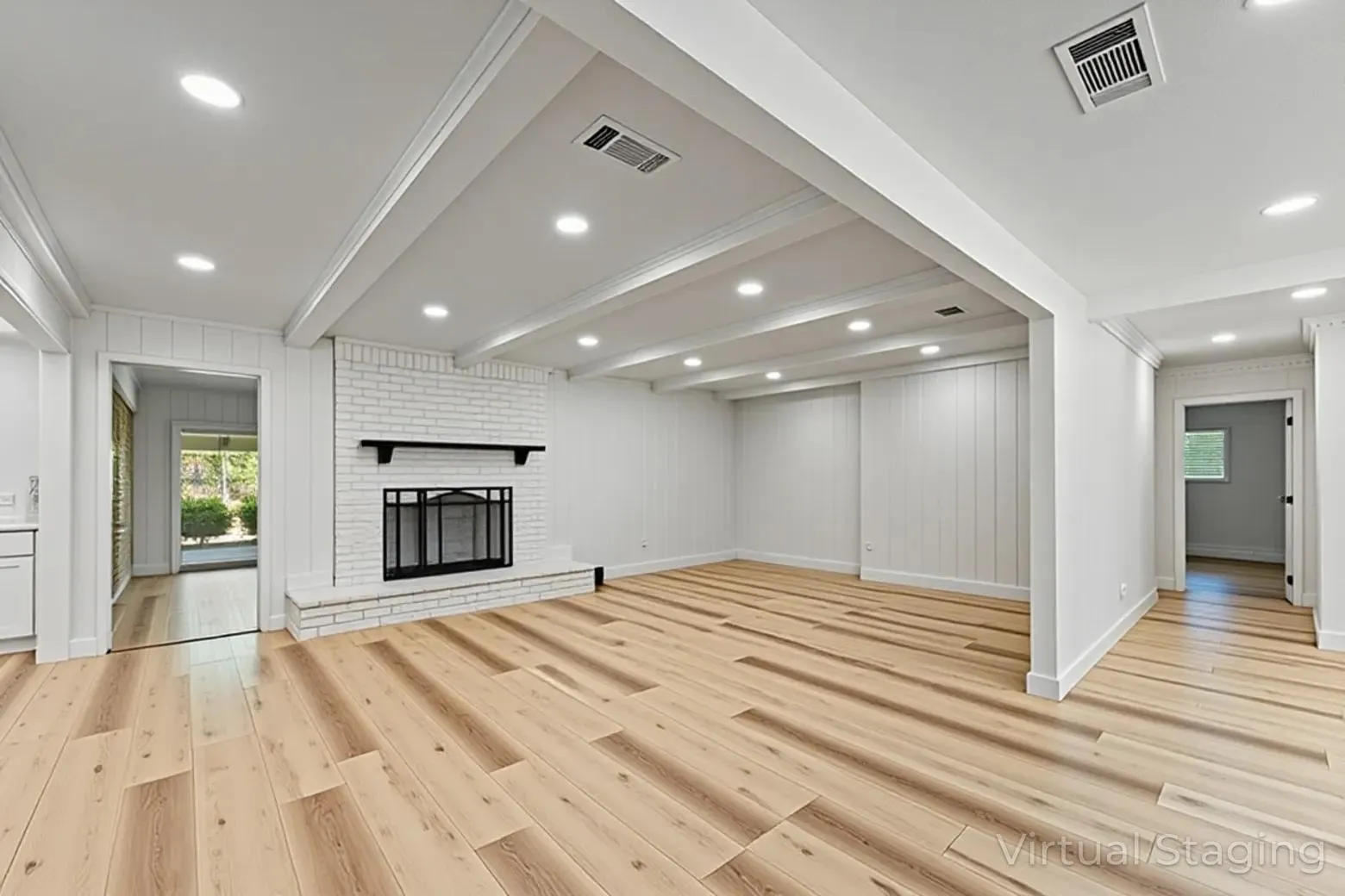 Light wood-finish flooring complements the white walls and white brick fireplace
