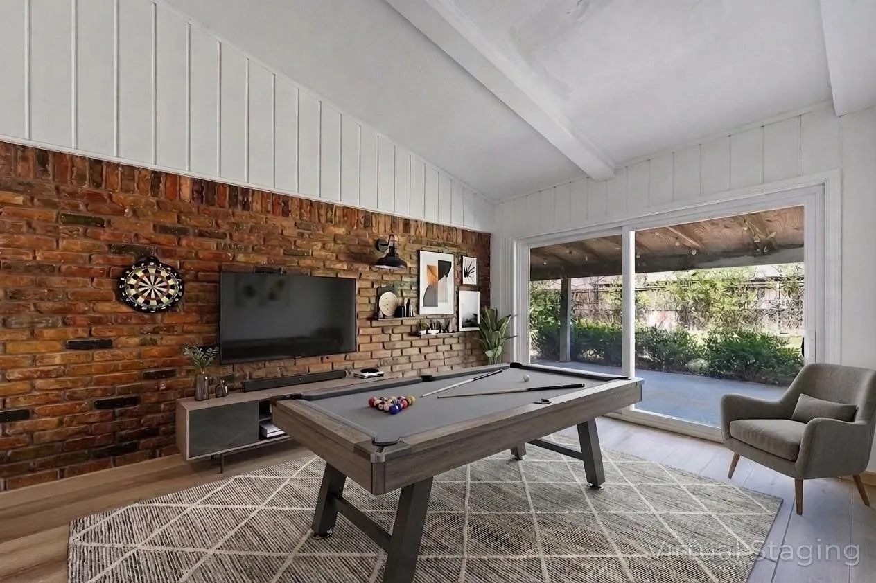 Exposed brick accent wall, wood-finish flooring, white wood paneling, and a full-light sliding glass door