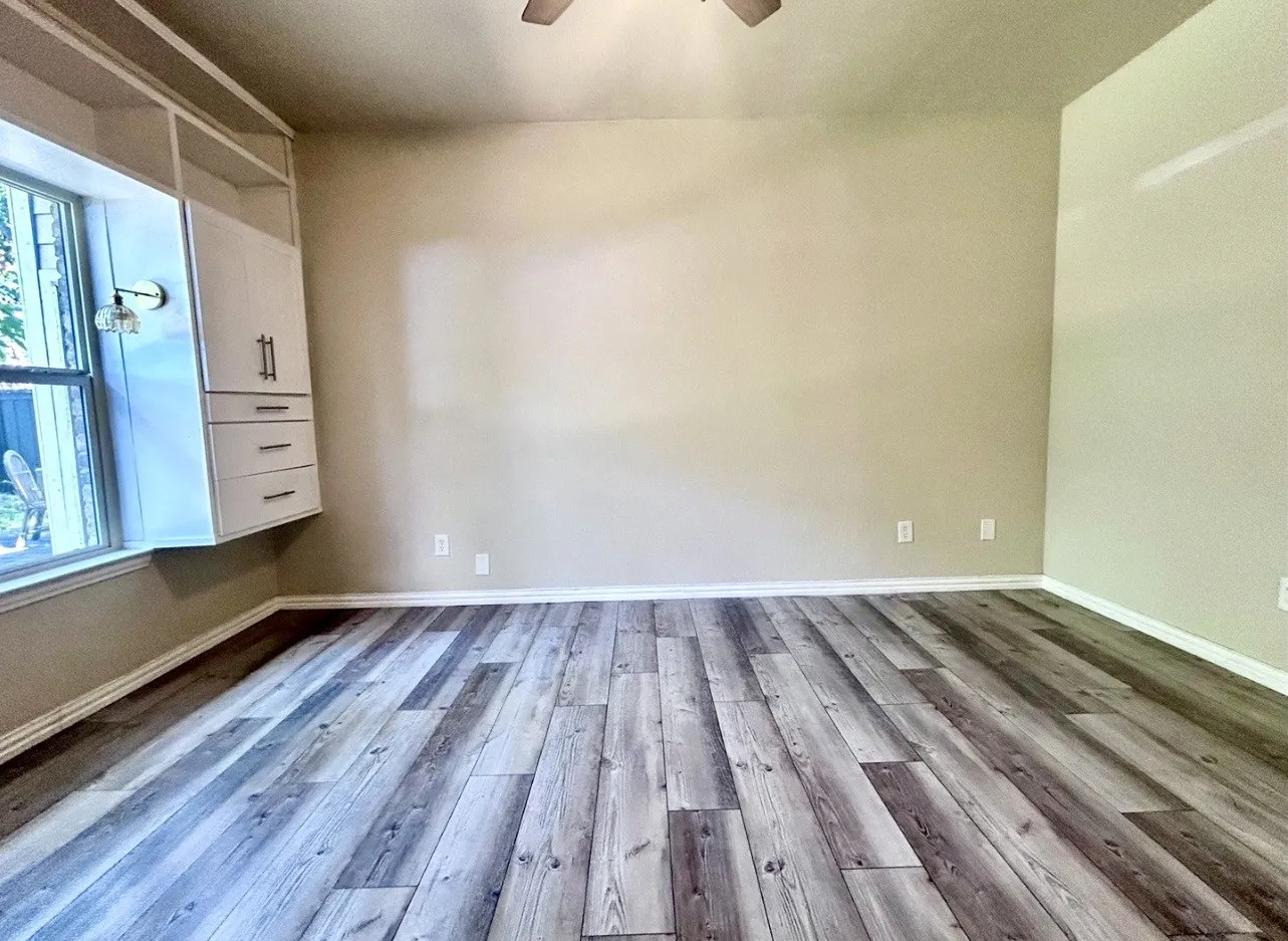 The bedroom features updated flooring, built in storage and a walk in closet.