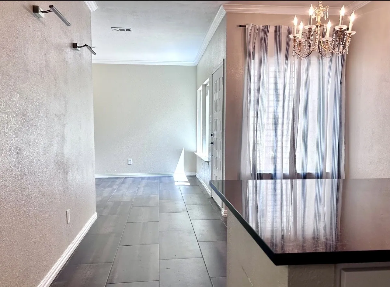 This view shows dining area to the right and is looking toward the foyer area.