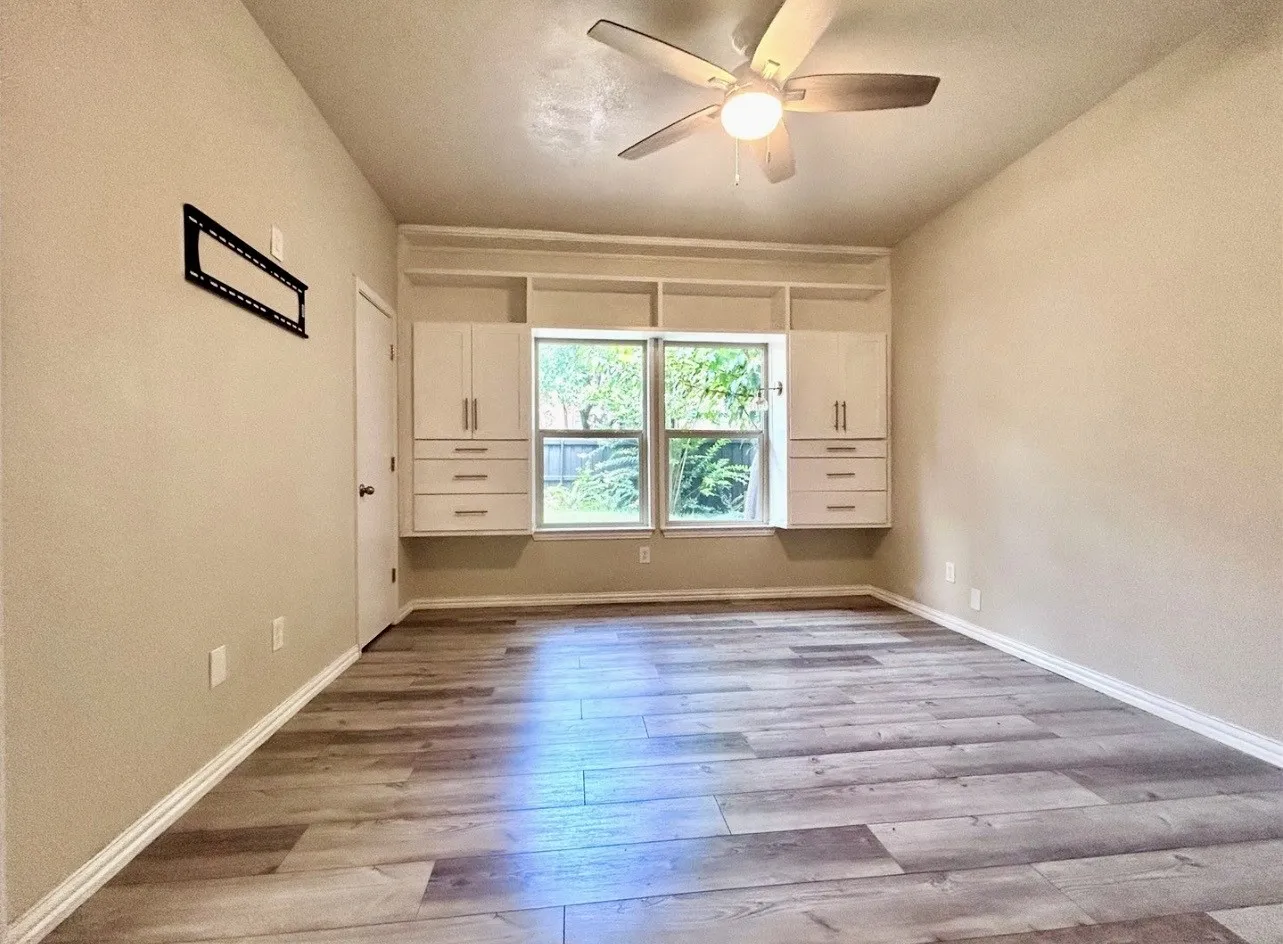 The bedroom features plenty of storage and natural light