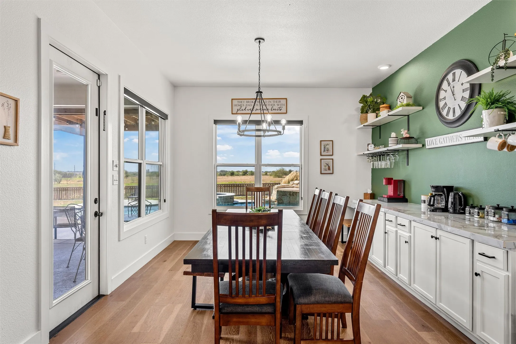 Wood-finish flooring throughout, with a large picture window, and glass-paneled patio door