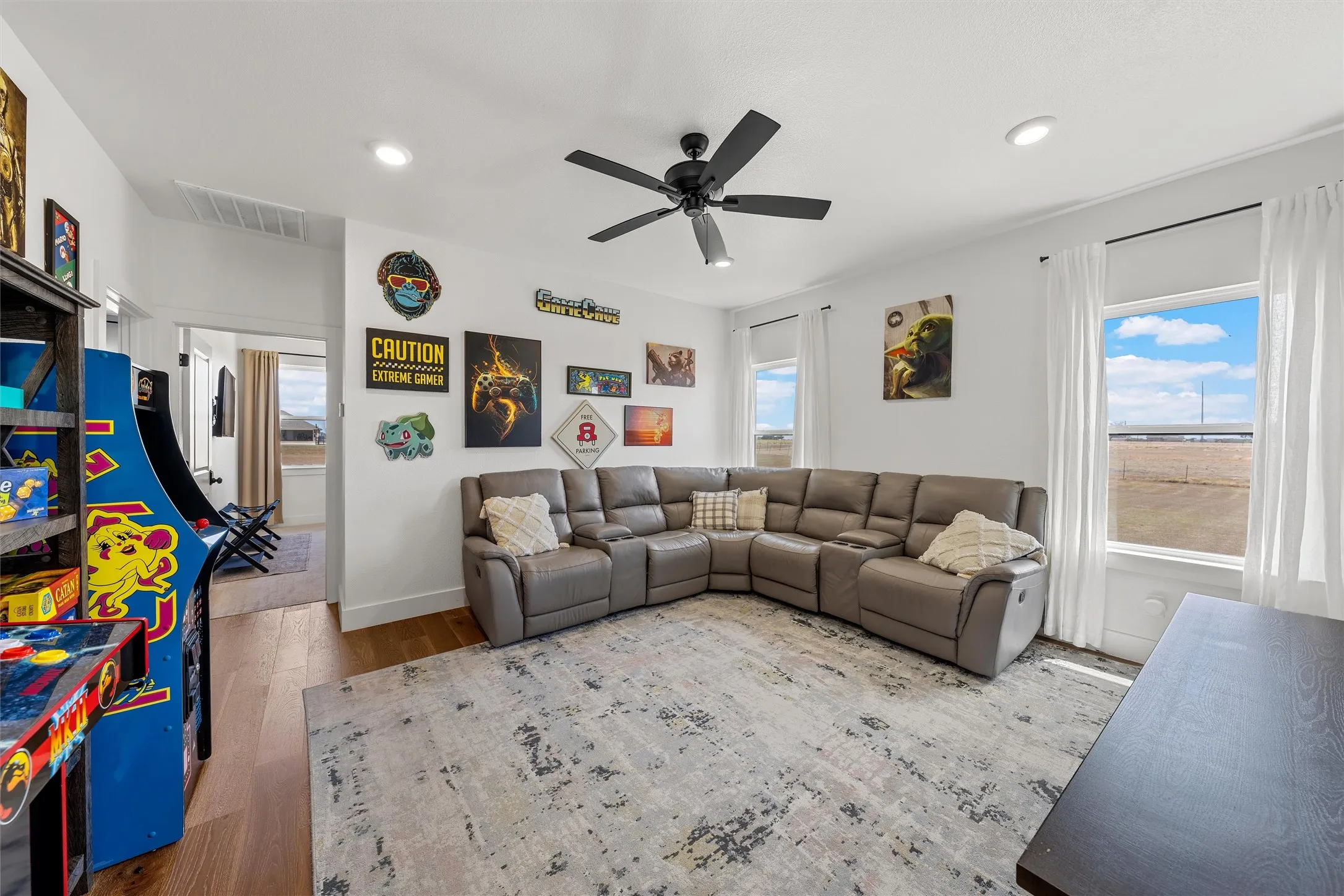 Recessed lighting, ceiling fan, and wood-finish flooring
