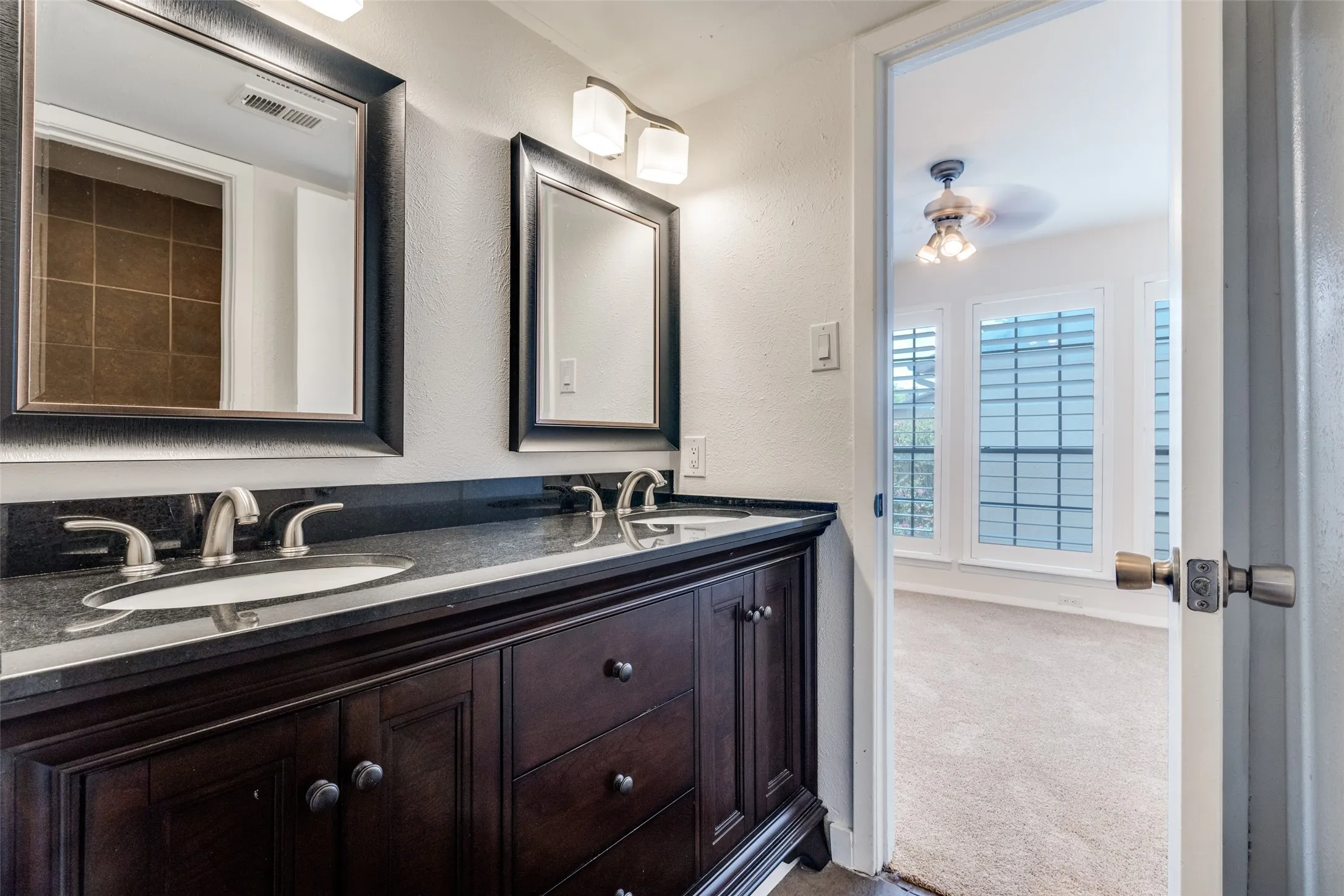 Updated full bathroom connects to primary master and guest room.